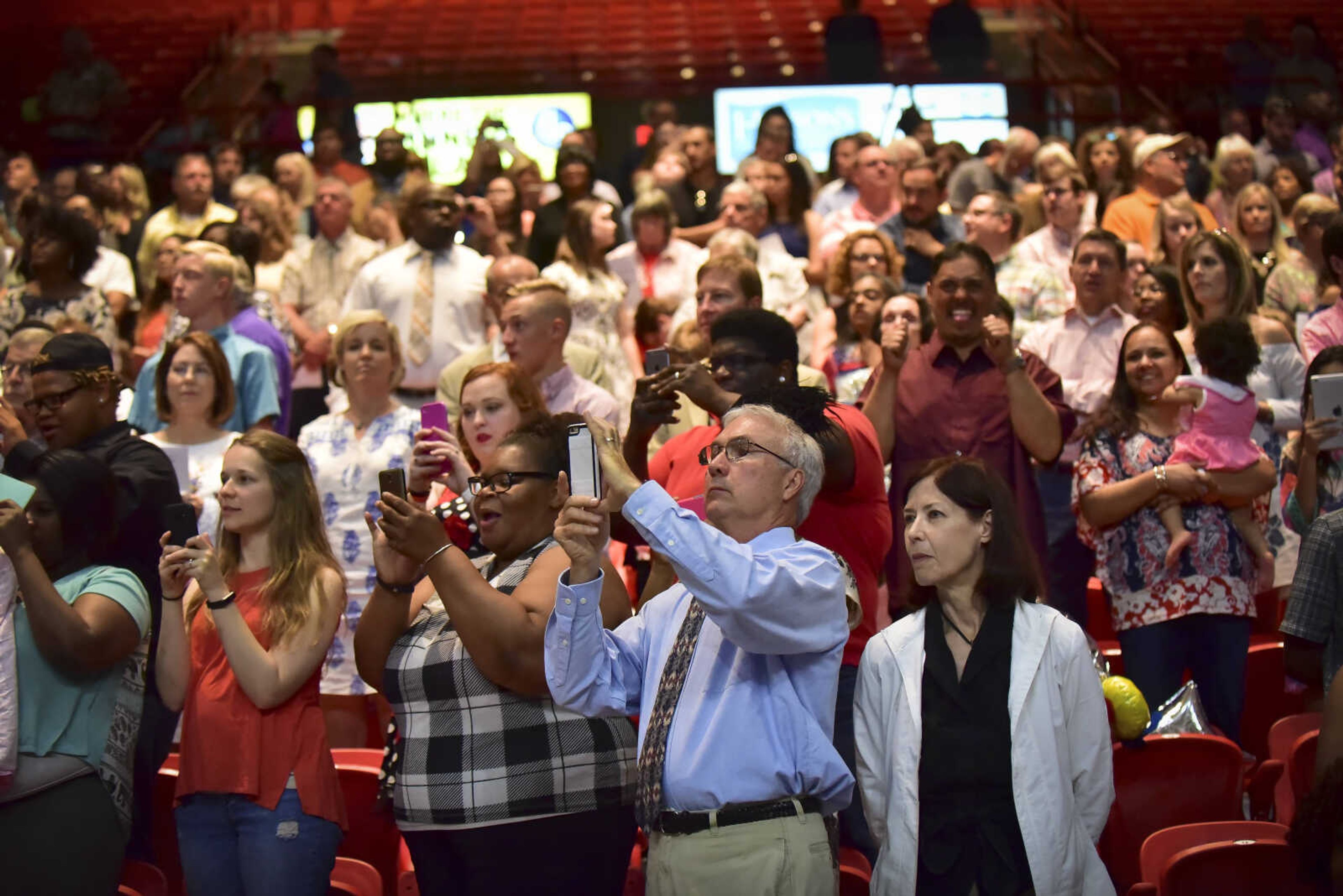 Parents take photos during Cape Girardeau Central High School graduation Sunday, May 14, 2017at the Show Me Center in Cape Girardeau.