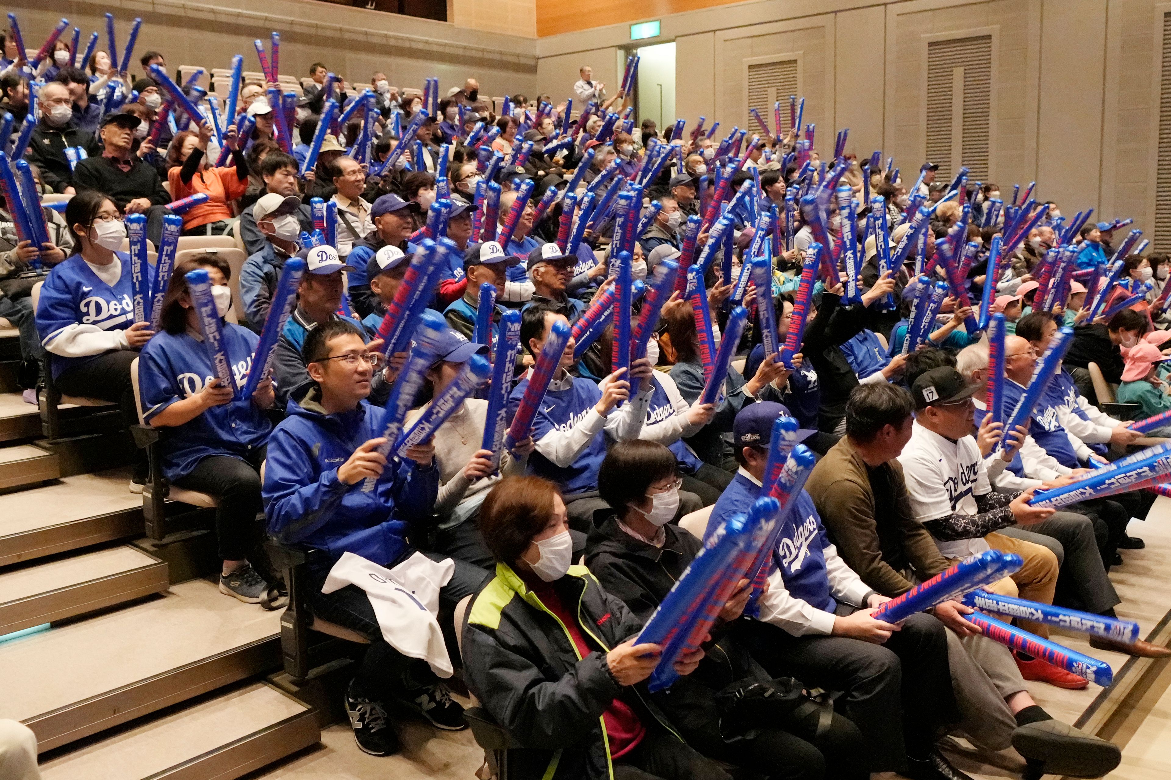 People watch a live stream before the start of Game 3 of the baseball World Series between the Los Angeles Dodgers and the New York Yankees during a public viewing event in Oshu, northeastern Japan, the hometown of Shohei Ohtani of the Dodgers, Tuesday, Oct. 29, 2024. (AP Photo/Eugene Hoshiko)