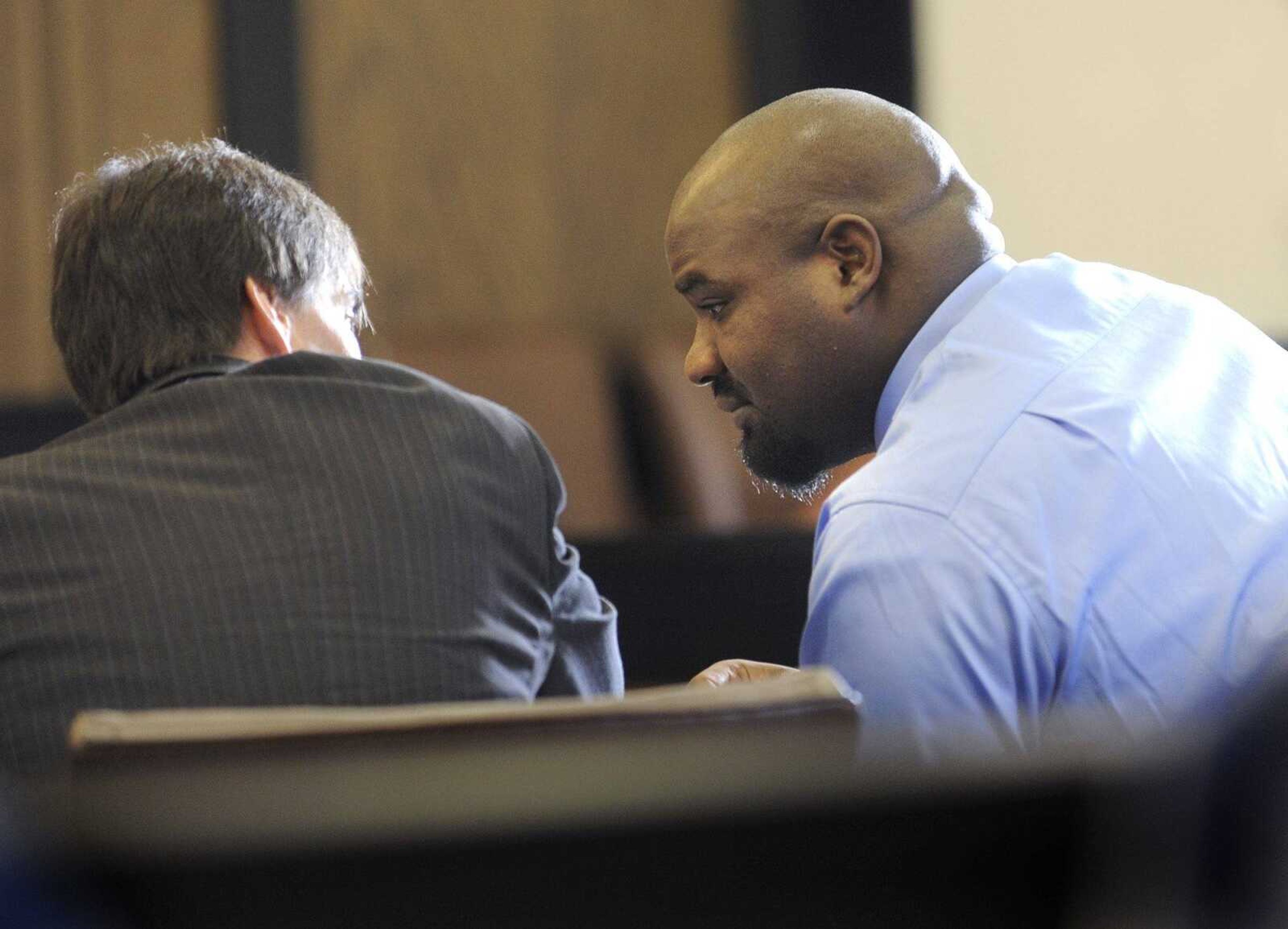 In this file photo, Ryan Patterson, right, talks with his attorney, David Kenyon, prior to opening statements Monday, Aug. 1, 2011 in the murder trial against Patterson at the Cape Girardeau County Courthouse in Jackson. (Fred Lynch)