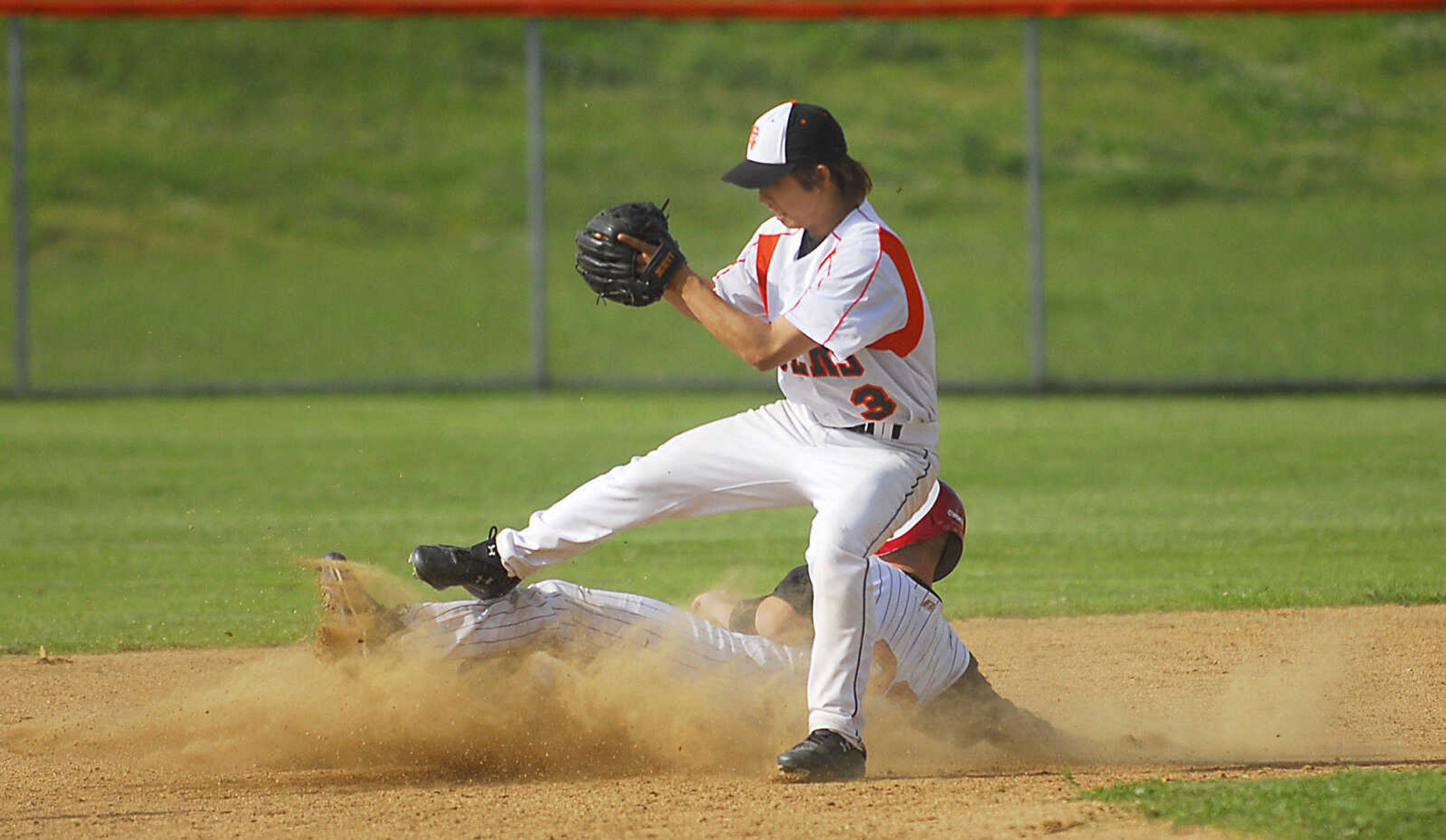 Chaffee's Trevor Cannon upends HidŽ Tanaka after a force out Monday, May 11, 2009, at Central High in Cape Girardeau.