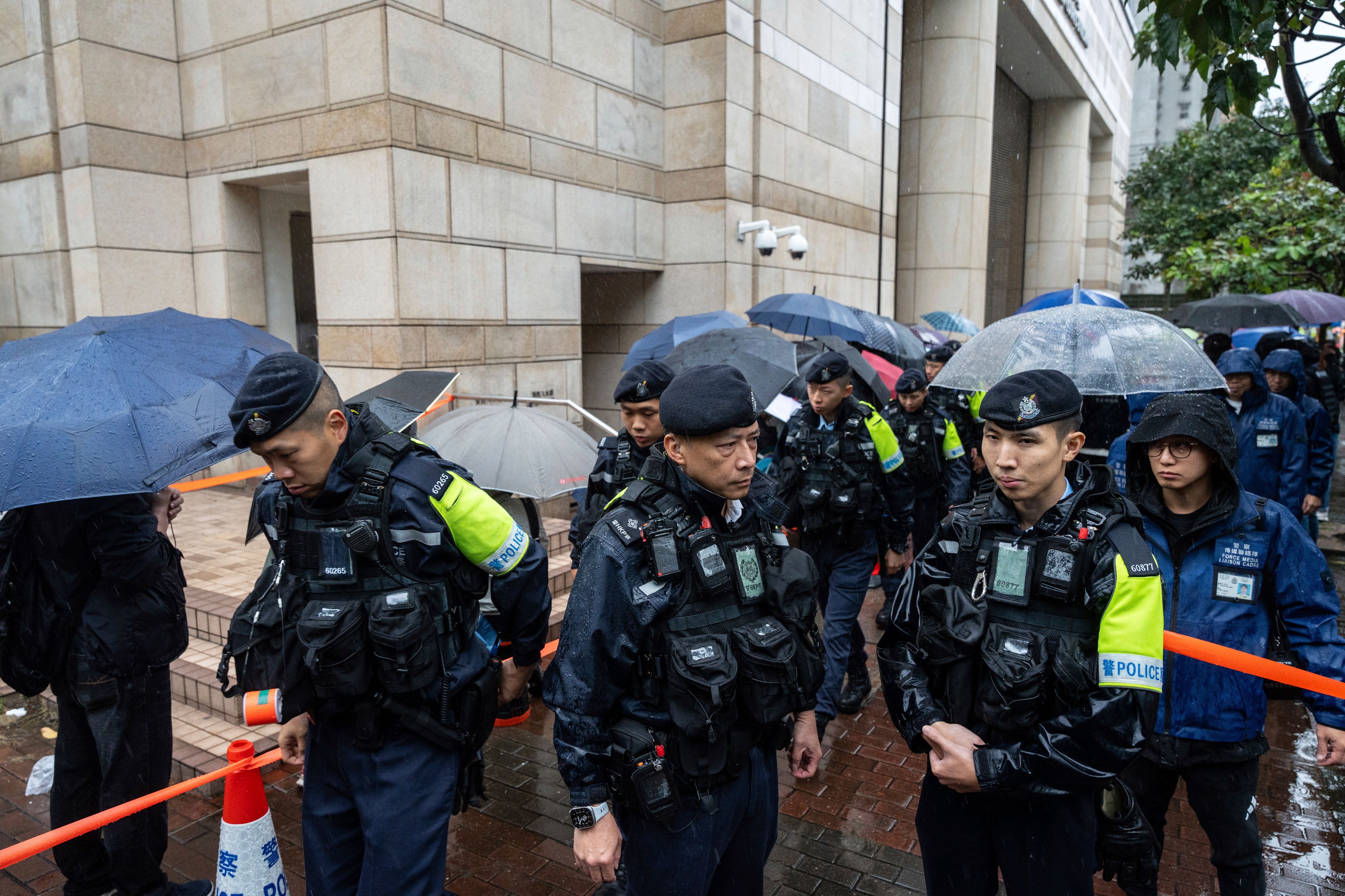 Police stand guard outside the West Kowloon Magistrates' Courts in Hong Kong, Wednesday, Nov. 20, 2024. (AP Photo/Chan Long Hei)