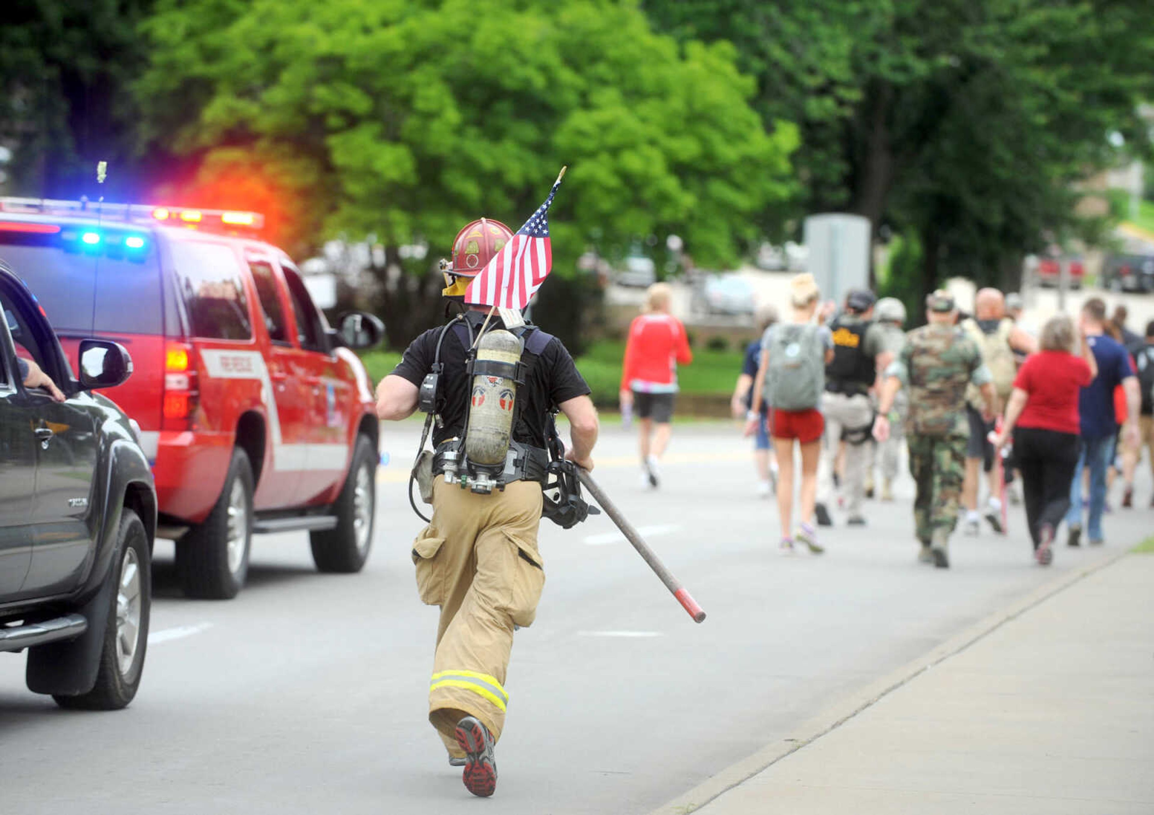 LAURA SIMON ~ lsimon@semissourian.com

Participants march west on Broadway during the first ever Carry the Load event, Monday, May 25, 2015, in Cape Girardeau.