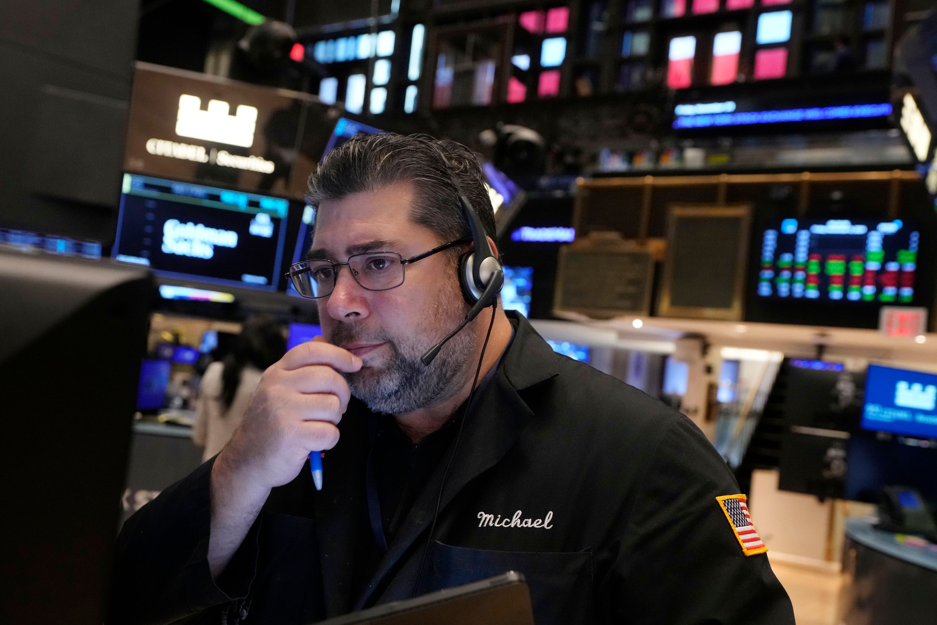 Trader Michael Capolinoi works on the floor of the New York Stock Exchange, Friday, Nov. 8, 2024. (AP Photo/Richard Drew)