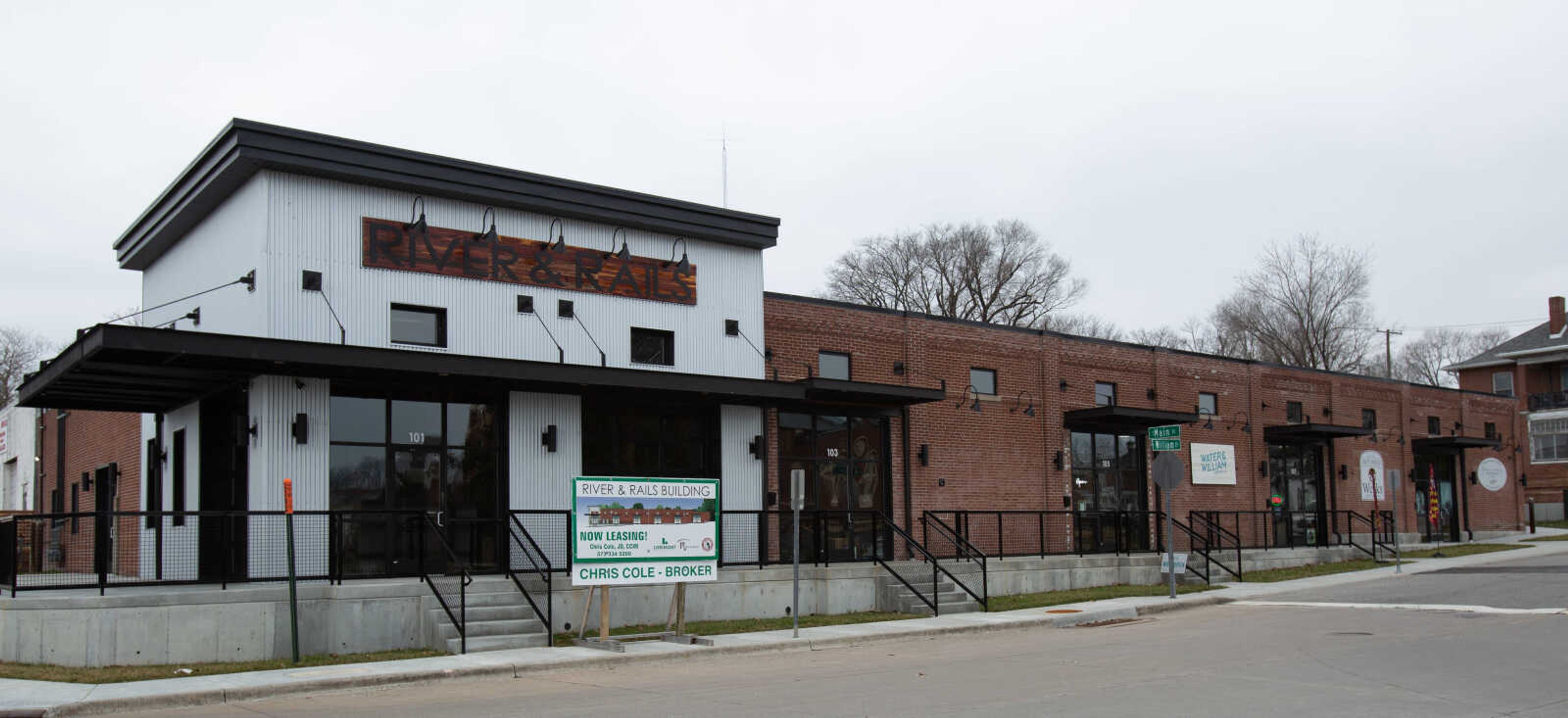 Past and present photos of the building on 101 William Street show how many changes the building went through before opening as the River & Rails retail complex which currently houses Water & William Olive Oil Co., Hot Sauce Werks and Frame A Memory Photography.