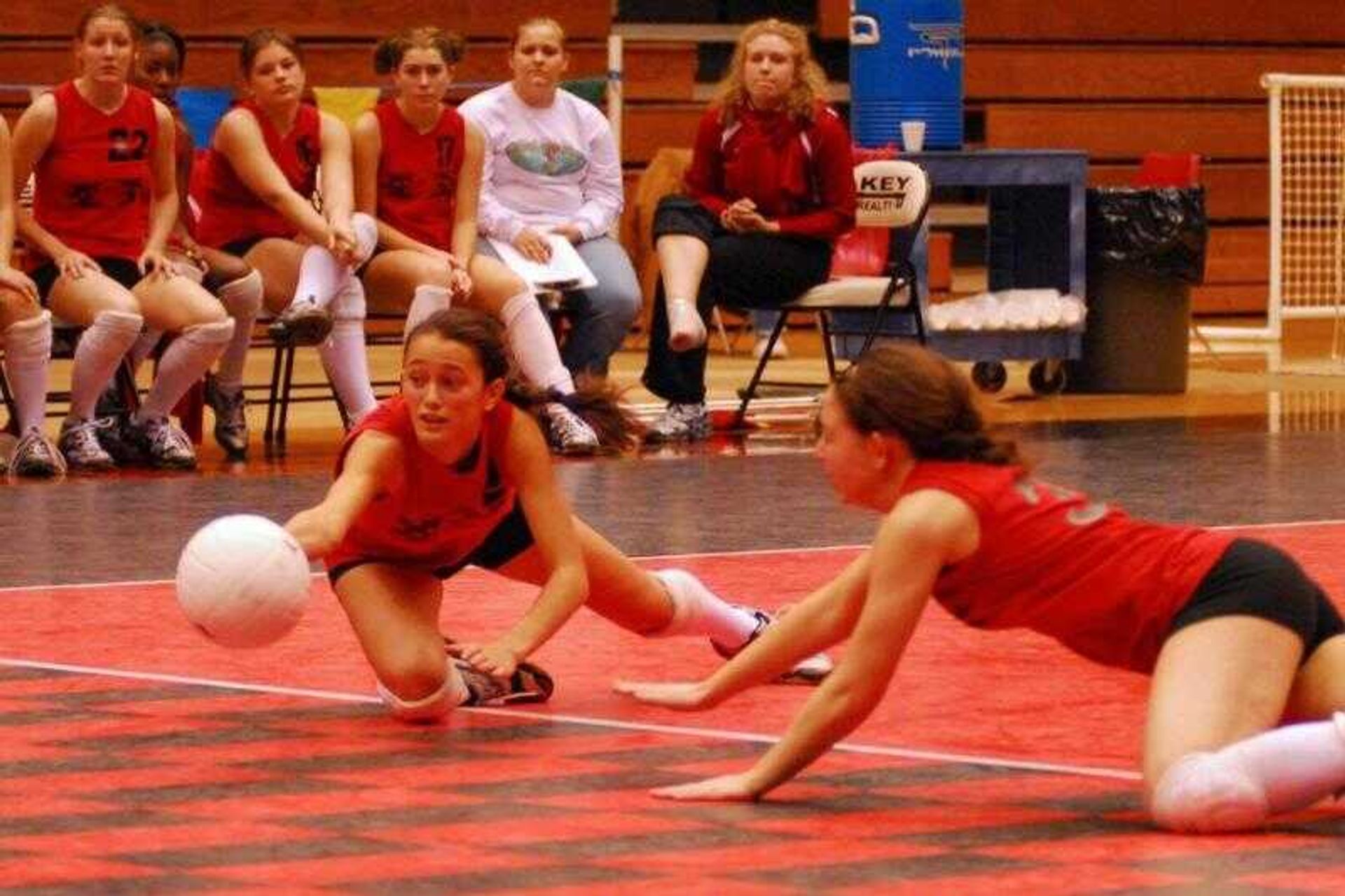 Bell City's Codie Lancaster, left, and Emilie Stephens attempted to dig the ball on the last point in the Cub's loss to Osceola on Saturday in the Class 1 third-place game.