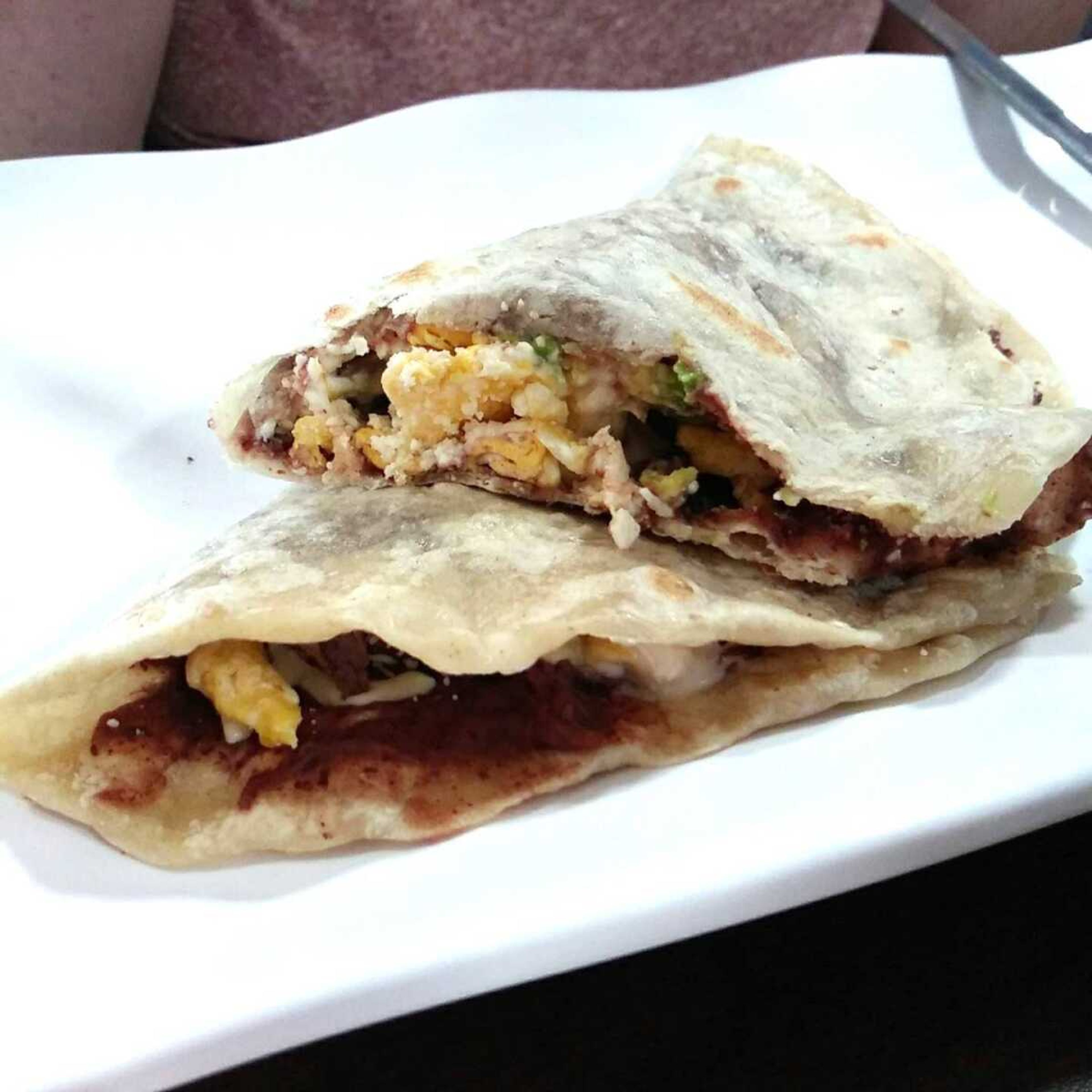 Baleada Especial, a huge homemade flour tortilla filled with steak, eggs, red refried beans, cheese, cream, and avocado.