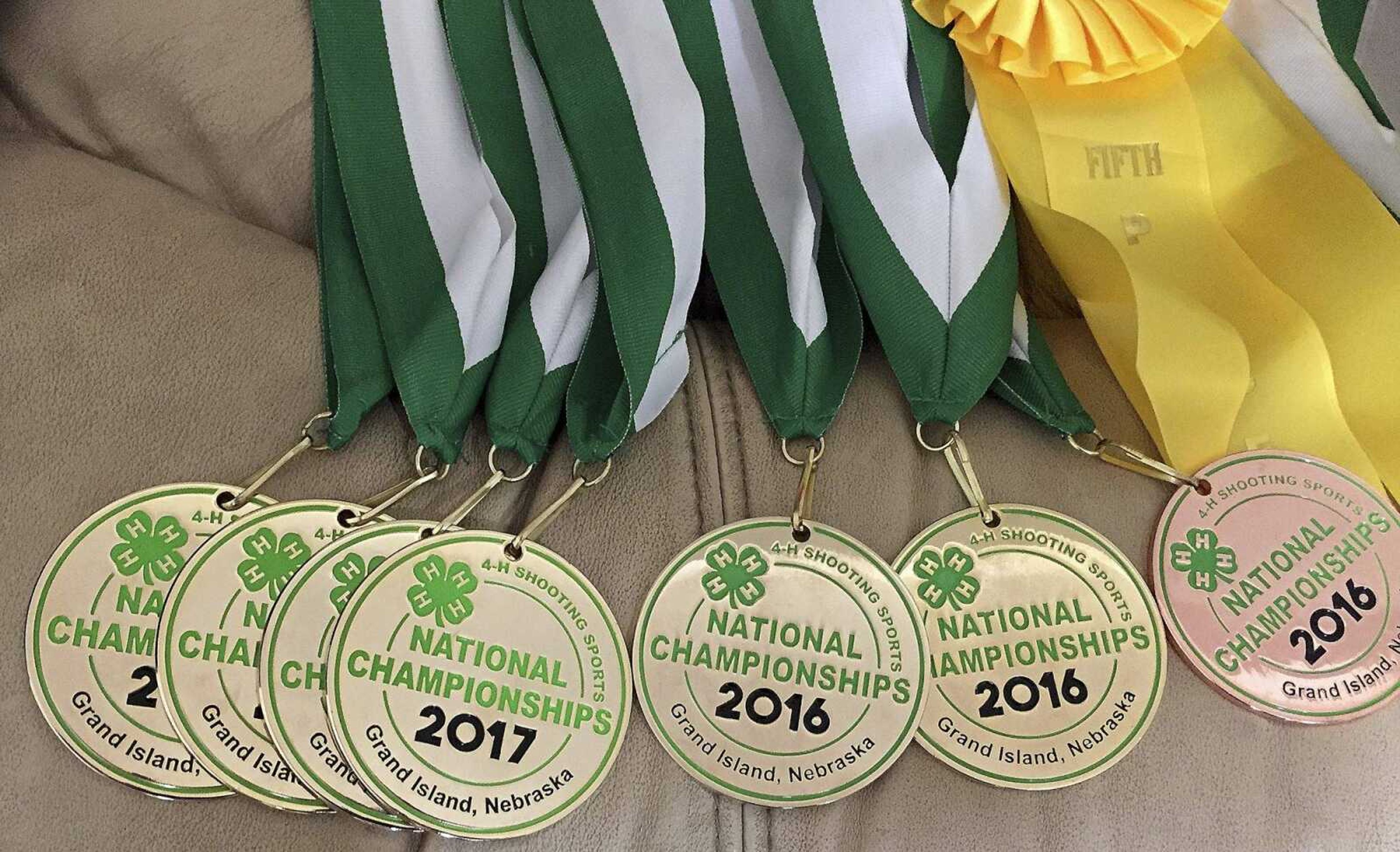 Hannah Persell displays an array of medals from the 4-H National Shooting Sports Championships.