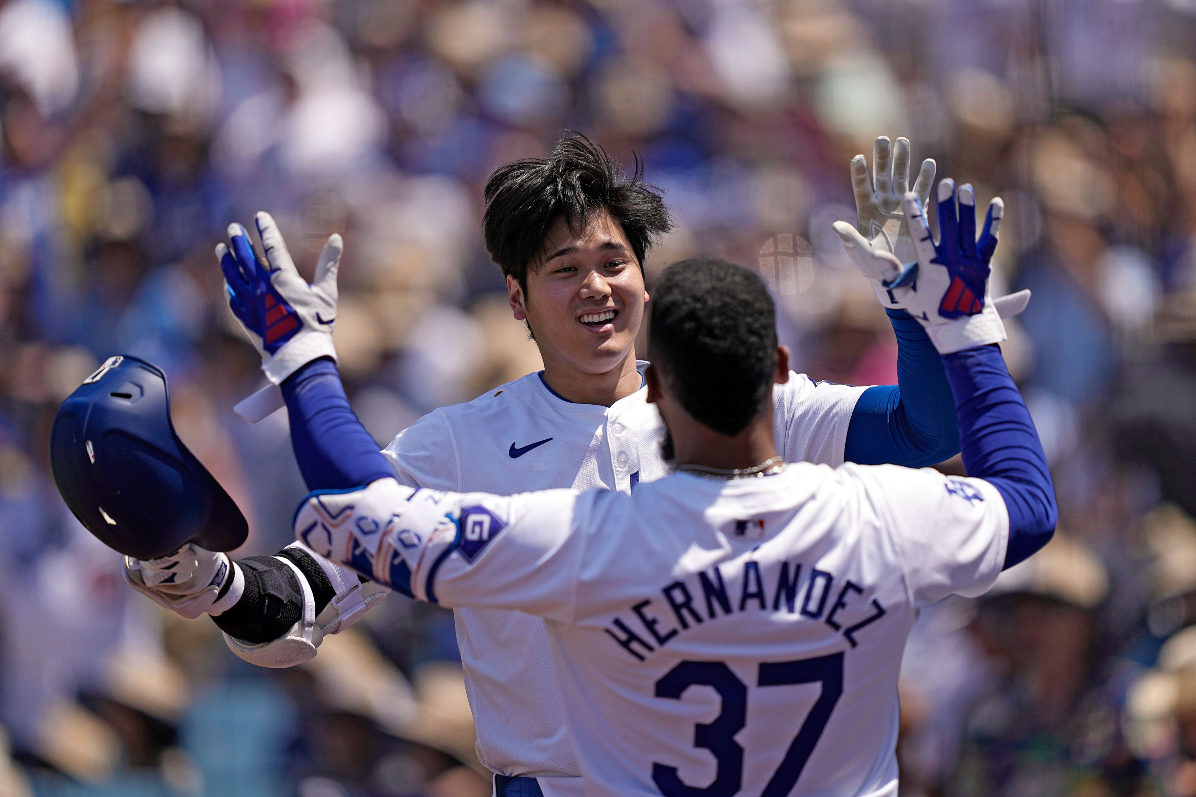 Los Angeles Dodgers' Shohei Ohtani, left, is congratulated by Teoscar Hernández after hitting a solo home run during the sixth inning of a baseball game against the Kansas City Royals Sunday, June 16, 2024, in Los Angeles. (AP Photo/Mark J. Terrill)