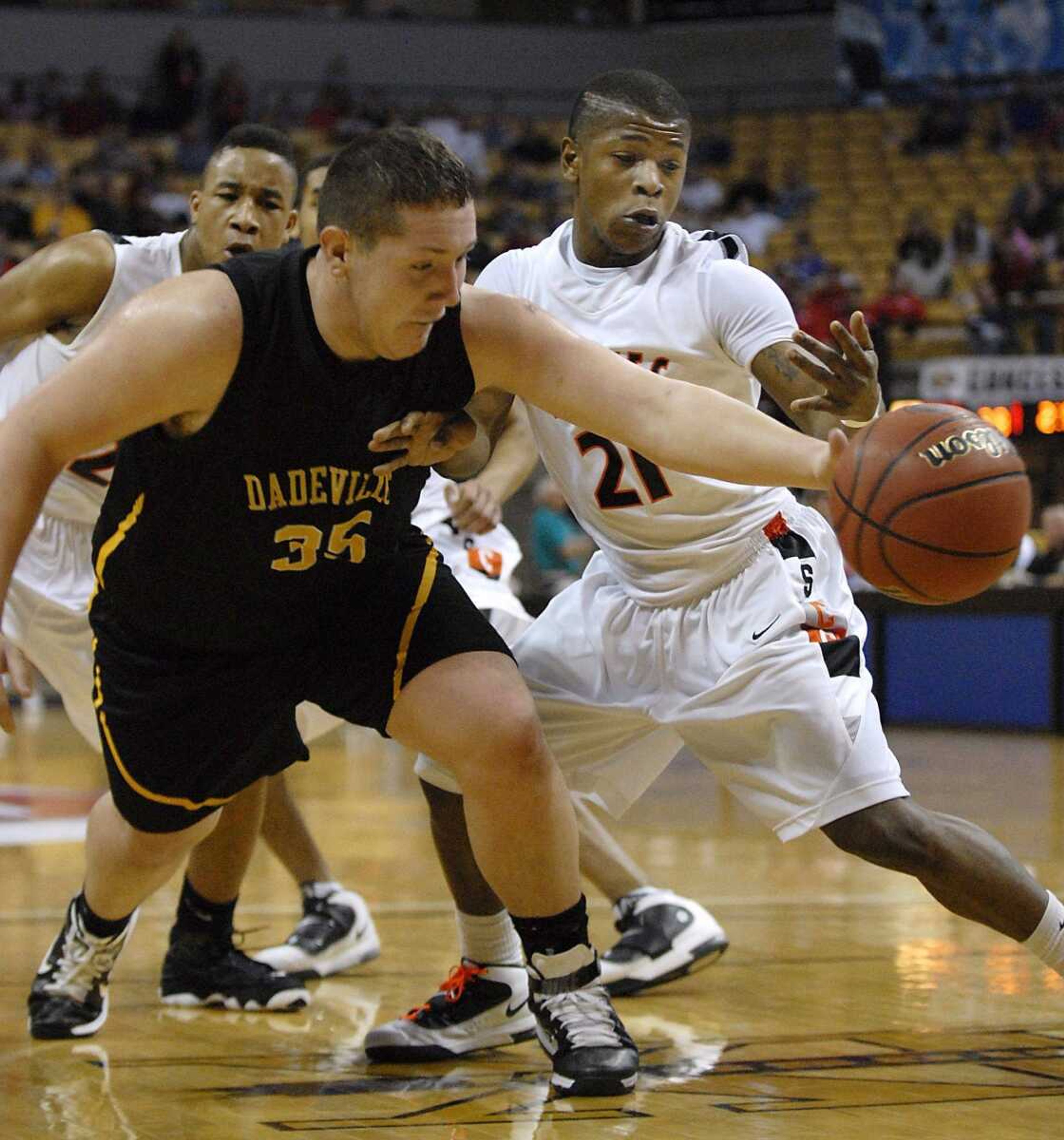 Scott County Central's Lamarcus Steward and Dadeville's Benjamin Dobbins reach for the ball during the second quarter of the Class 1 championship game Saturday in Columbia, Mo. Scott County Central won 69-54. (Kristin Eberts)