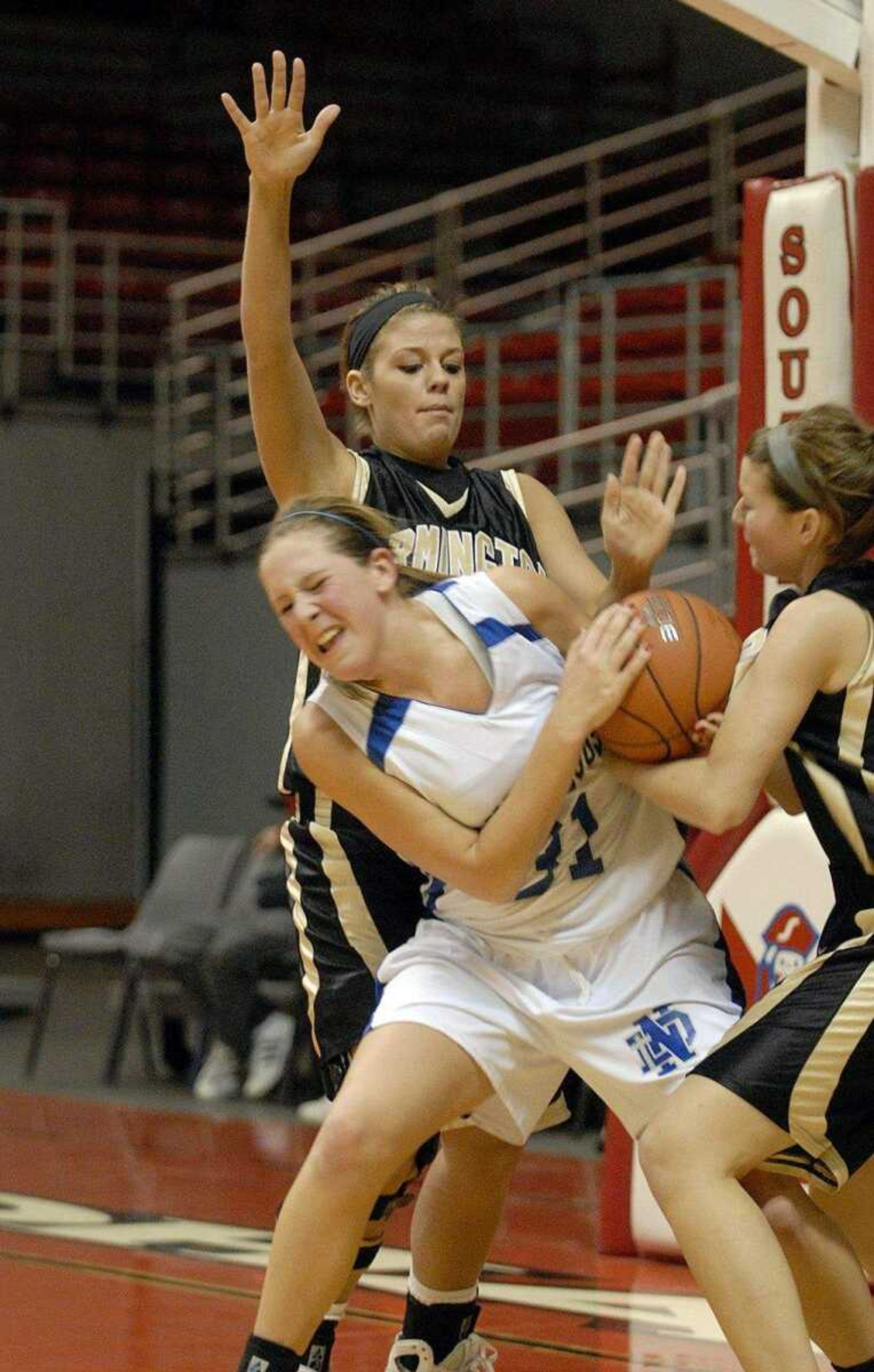 ELIZABETH DODD ~ edodd@semissourian.com
Notre Dame's Meghan Dohogne, center, attempts to grab the ball from Farmington's Brittany Gladbach, right, and Holli Hoehn in the first half of the Holiday Classic Tuesday at the Show Me Center.