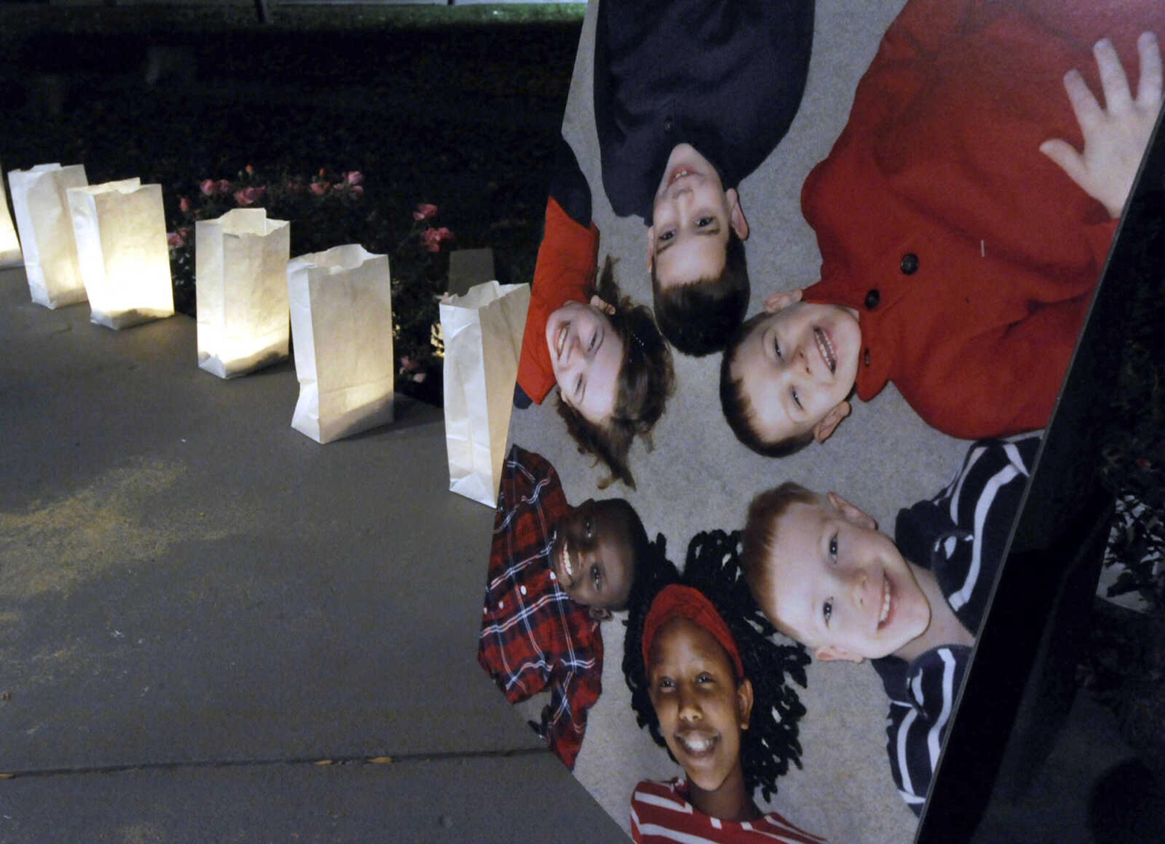 A photo of adoptable children was displayed at the Orphan Sunday Candlelight Vigil at Common Pleas Courthouse gazebo Sunday, Nov. 2, 2014 in Cape Girardeau.