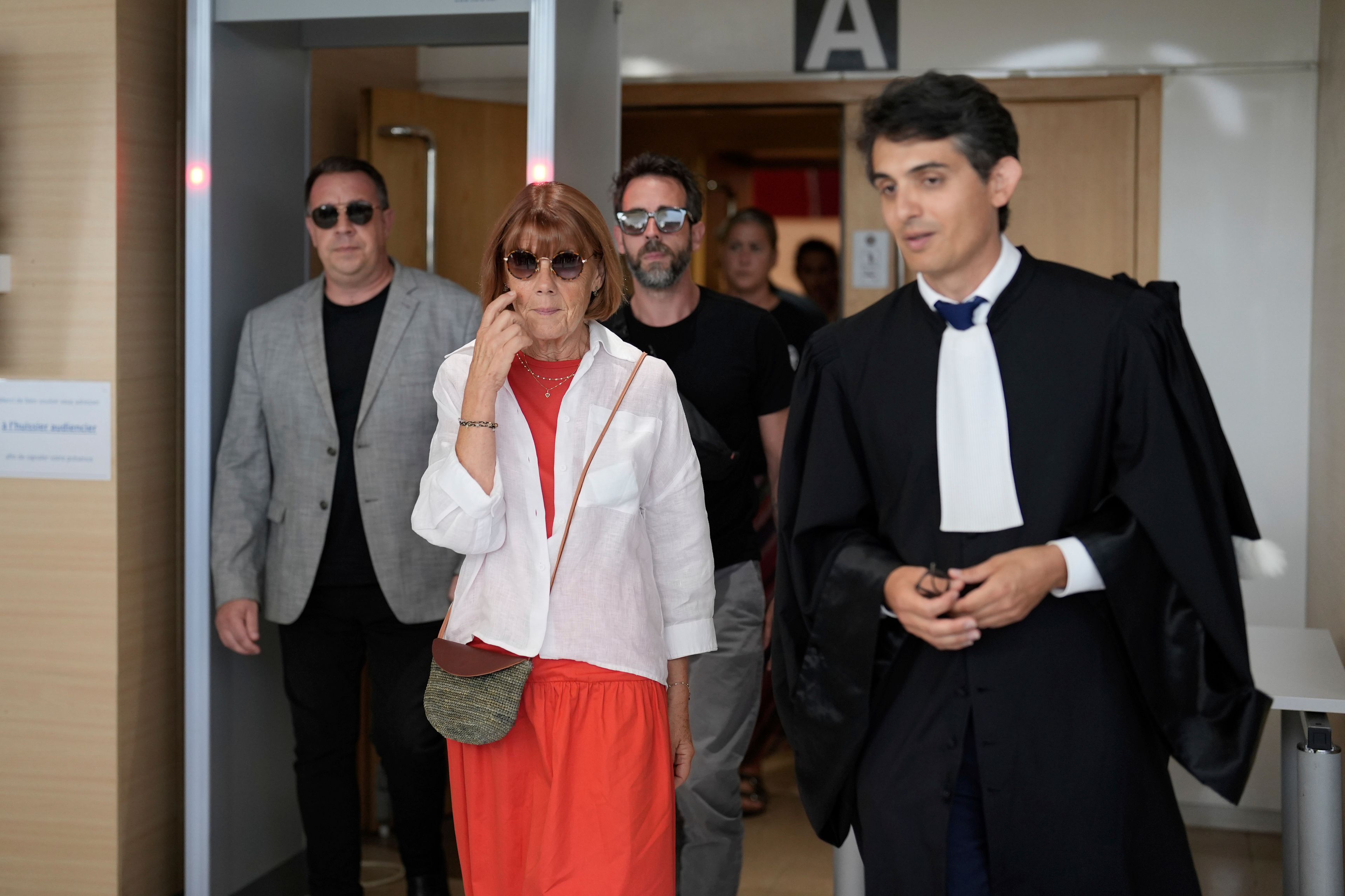 FILE - Gisele Pelicot, center left, leaves the Avignon court house with her sons, David, left, Florian, center background and her lawyer Stephane Babonneau, right, in Avignon, southern France, on Sept. 5, 2024. (AP Photo/Lewis Joly, File)