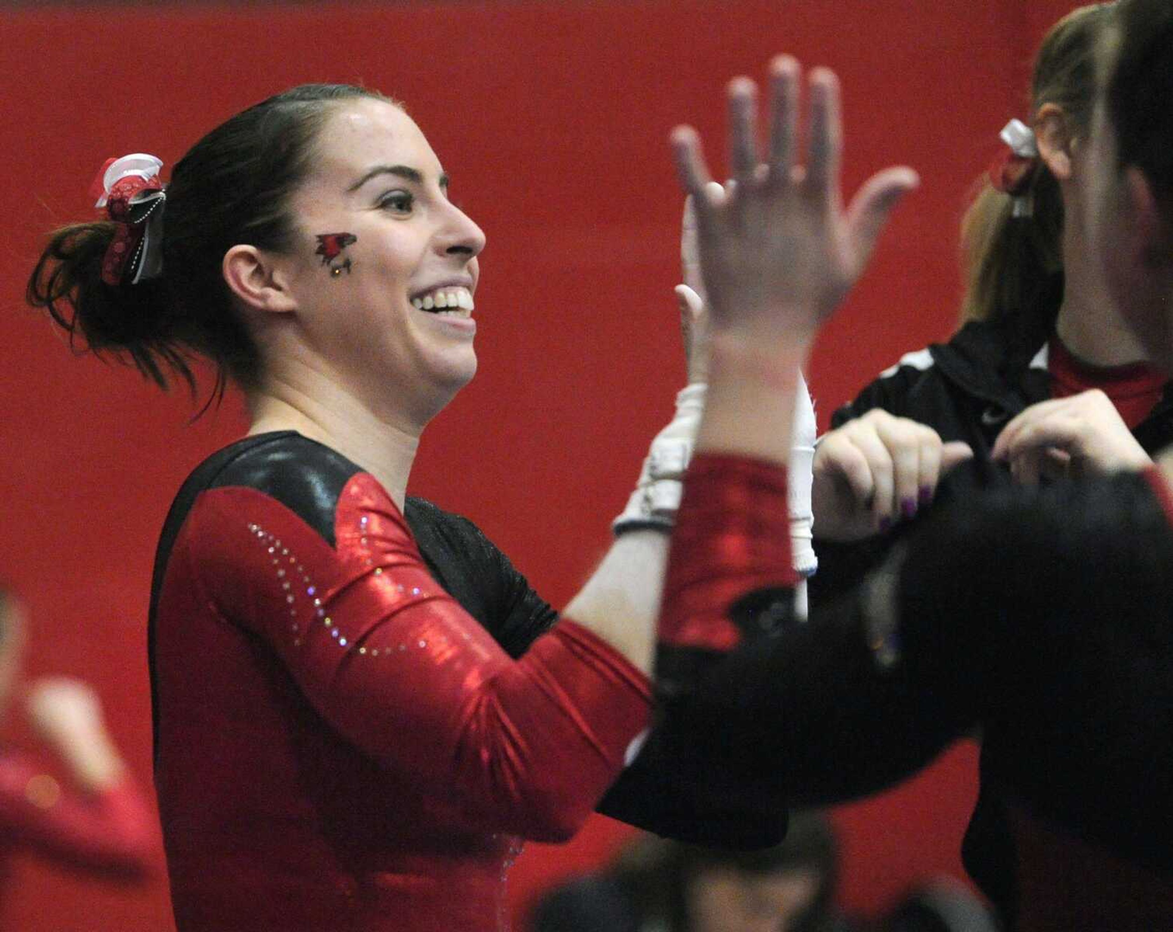 Southeast Missouri State's Margaret O'Neal is congratulated after competing on the uneven bars during a meet with Texas Woman's University Friday, March 16, 2012 at Houck Field House. (Fred Lynch)