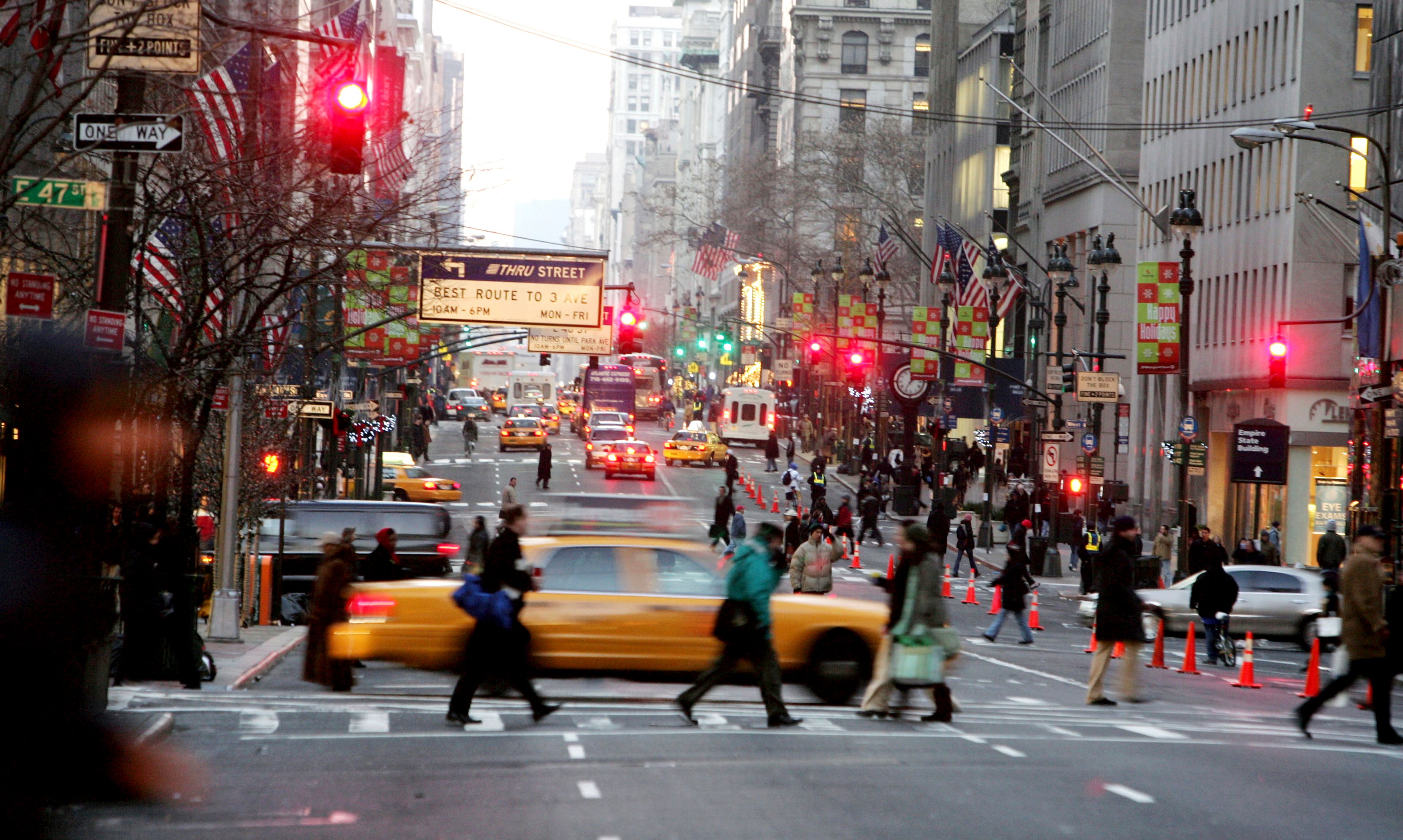 FILE - Vehicles and pedestrians make their way down Fifth Avenue in New York, Dec. 22, 2005, . (AP Photo/Diane Bondareff, File)