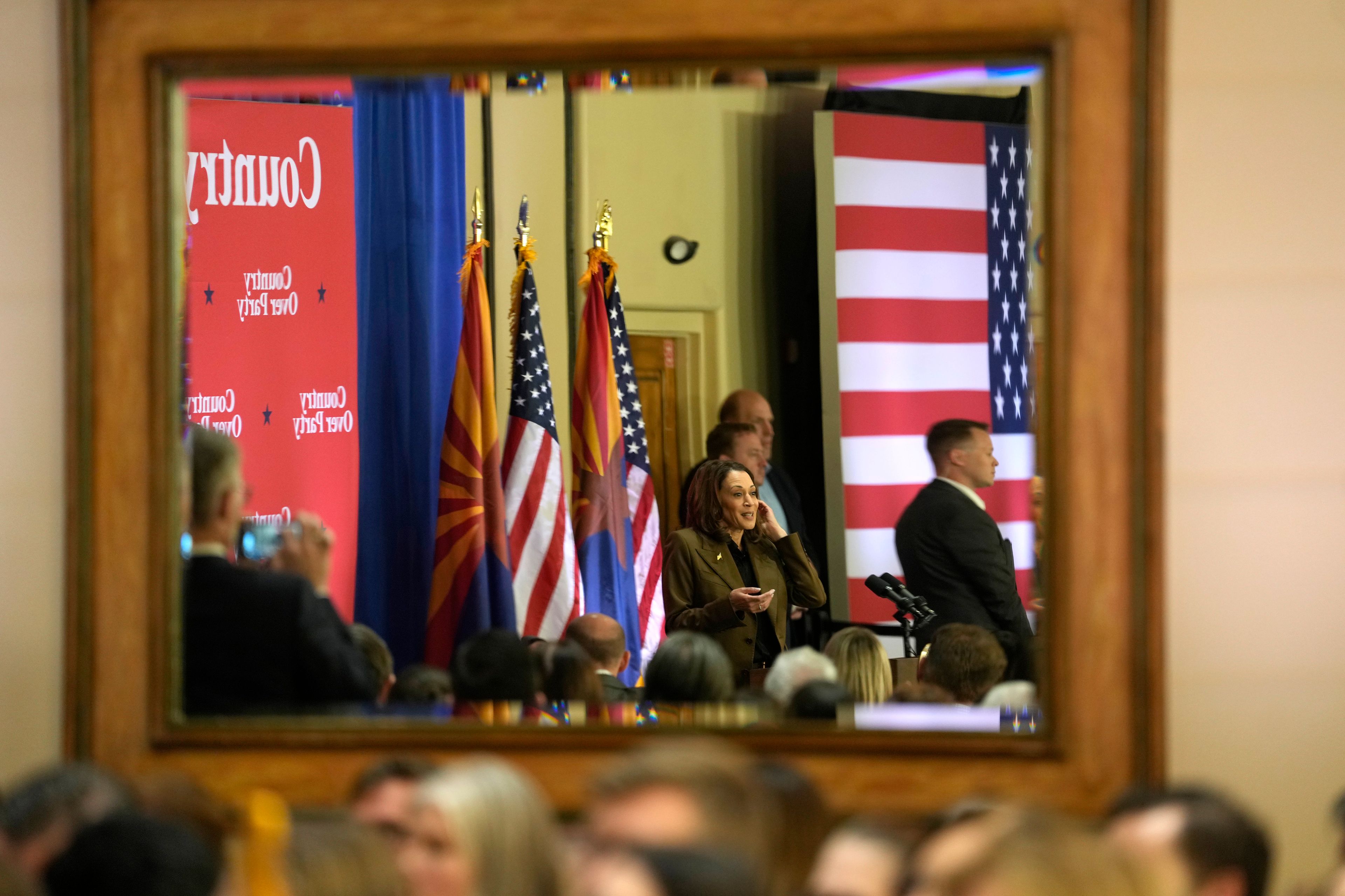 Democratic presidential nominee Vice President Kamala Harris appears in a mirror's reflection as she speaks at a campaign event Friday, Oct. 11, 2024, at the Grayhawk Golf Club in Scottsdale, Ariz. (AP Photo/Ross D. Franklin)