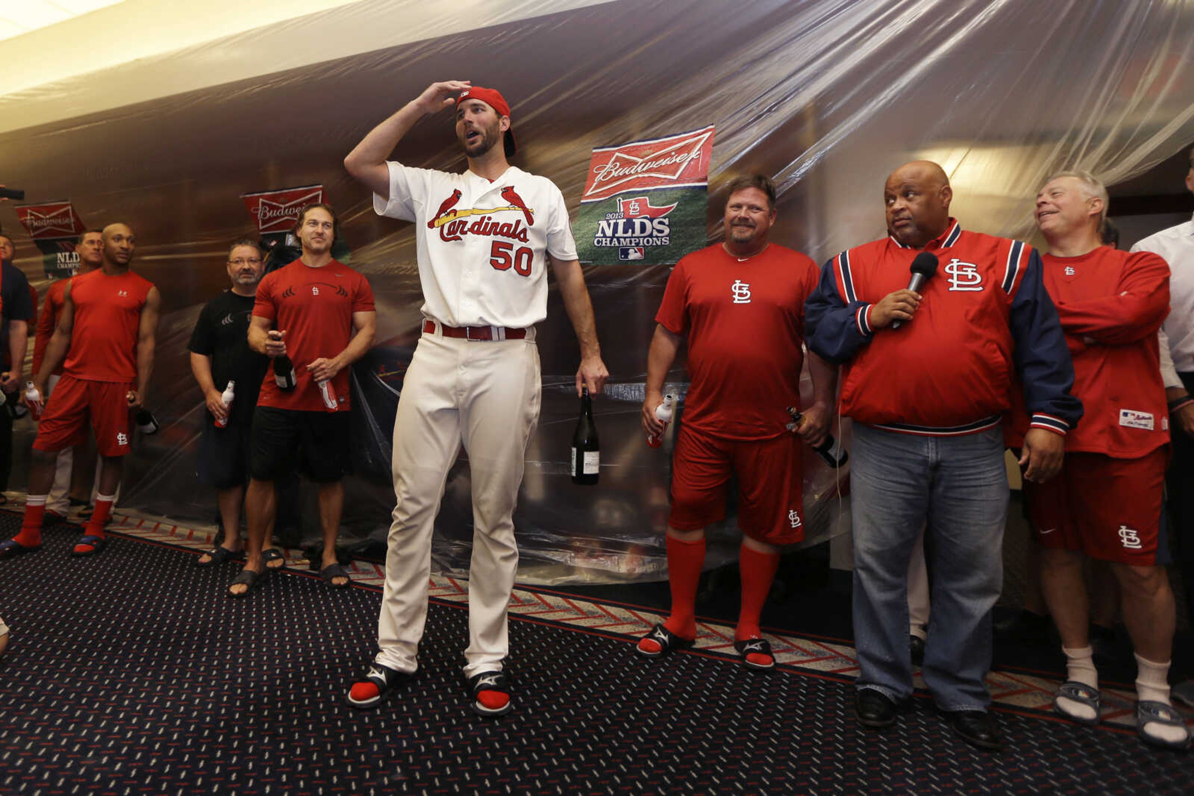 St. Louis Cardinals pitcher Adam Wainwright (50) talks to his teammates in the clubhouse after the Cardinals beat the Pittsburgh Pirates in Game 5 in a National League baseball division series on Wednesday, Oct. 9, 2013, in St. Louis. (AP Photo/Jeff Roberson)