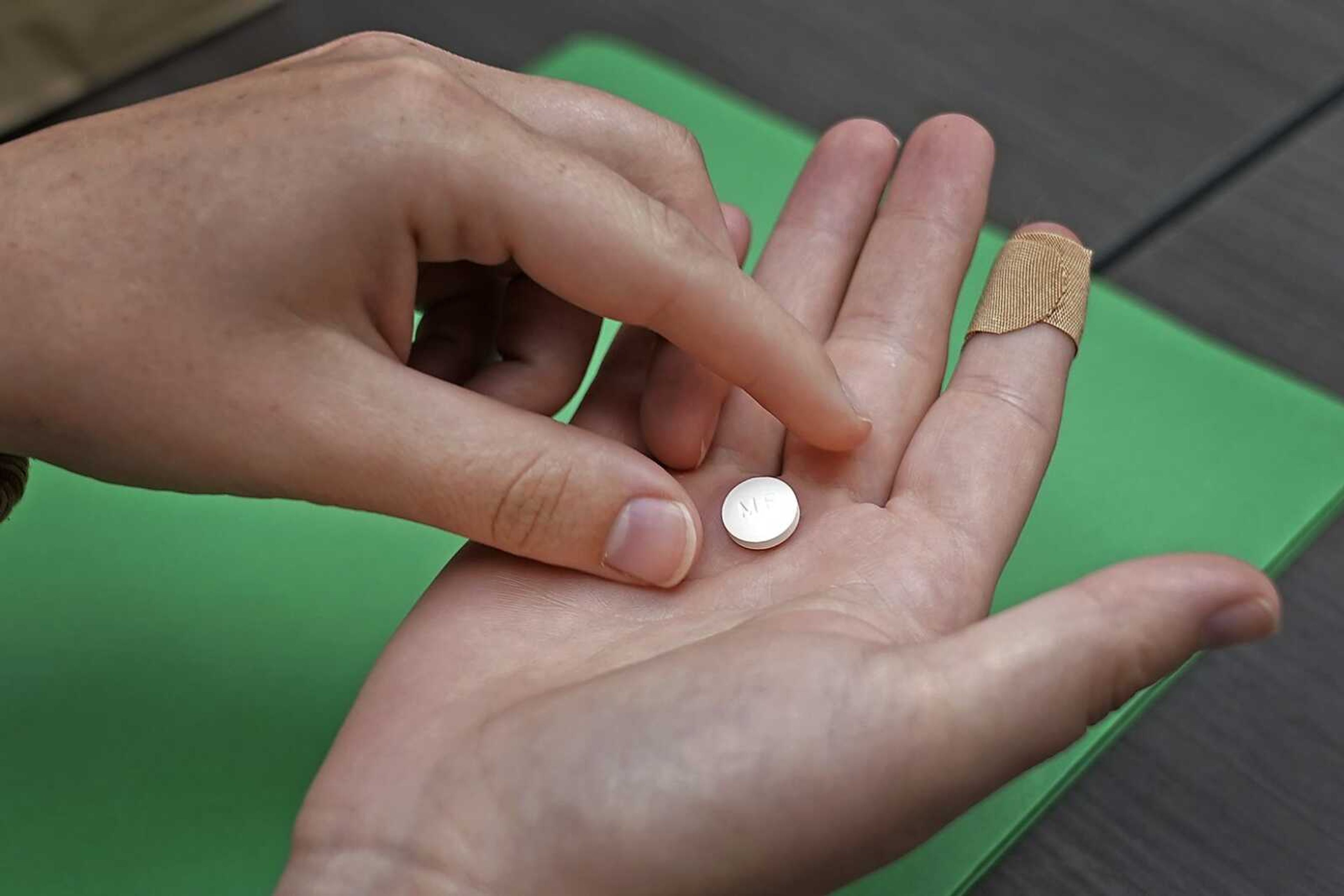 Haley Ruark prepares to take the first of two pills for a medical abortion during a visit to a Planned Parenthood clinic Wednesday, Oct. 12, in Kansas City, Kansas.