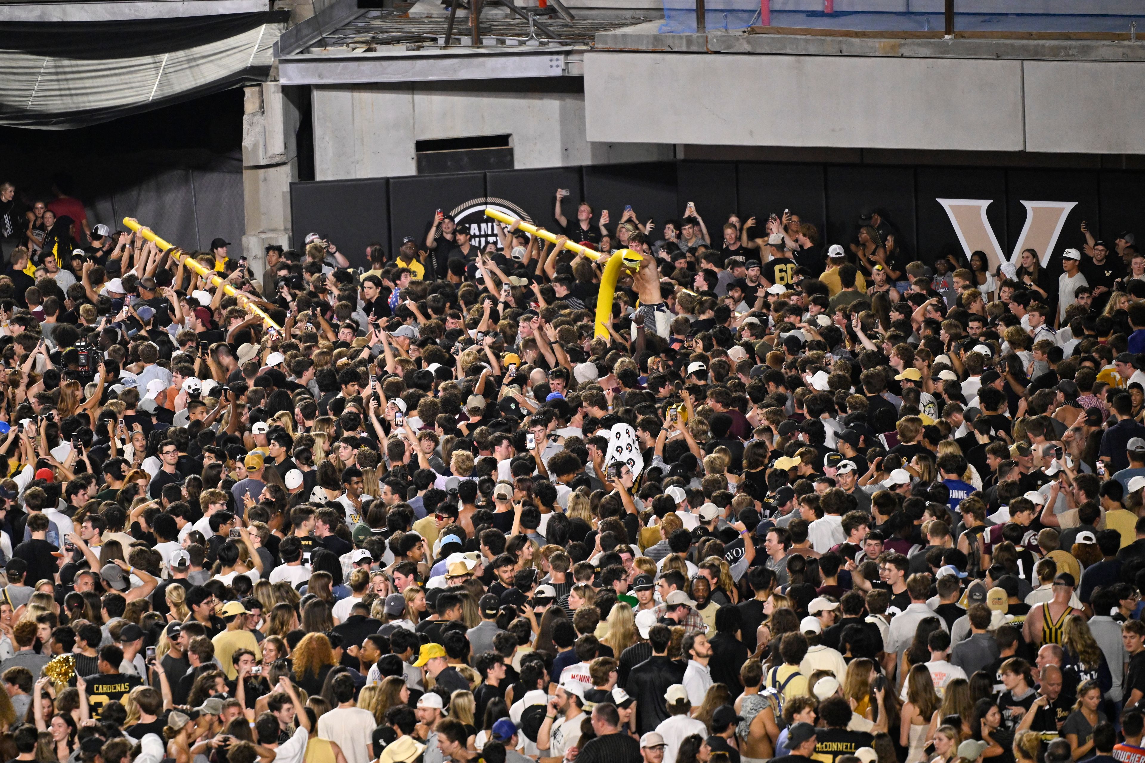 FILE - Vanderbilt fans carry a goalpost around the field after defeating Alabama in NCAA football game on Saturday, Oct. 5, 2024, in Nashville, Tenn. (AP Photo/John Amis, File)