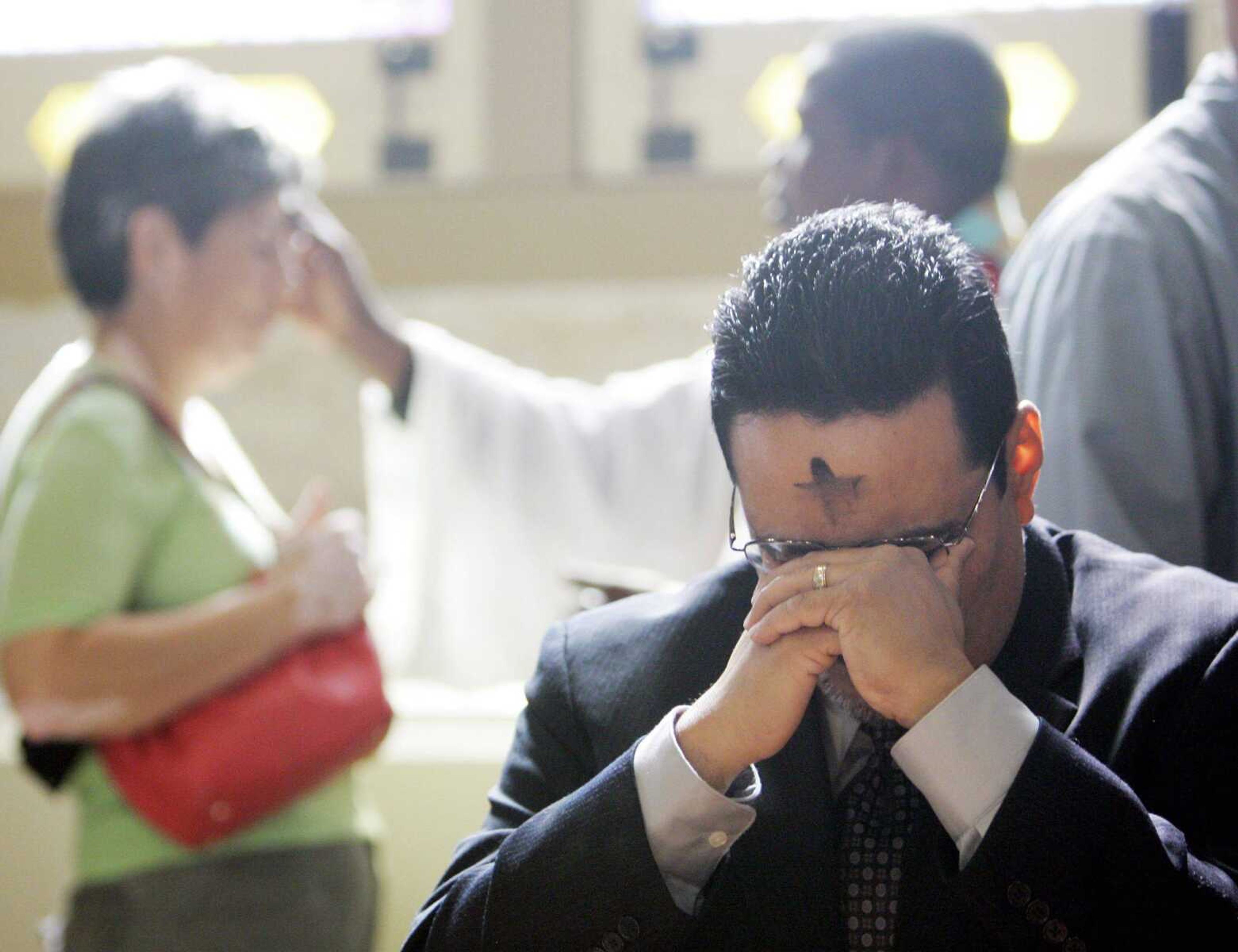 A parishioner, with an ash cross on his forehead, prays during an Ash Wednesday service at San Fernando Cathedral in San Antonio, Wednesday, Feb. 21, 2007, marking the beginning of Lent. (AP Photo/Eric Gay)