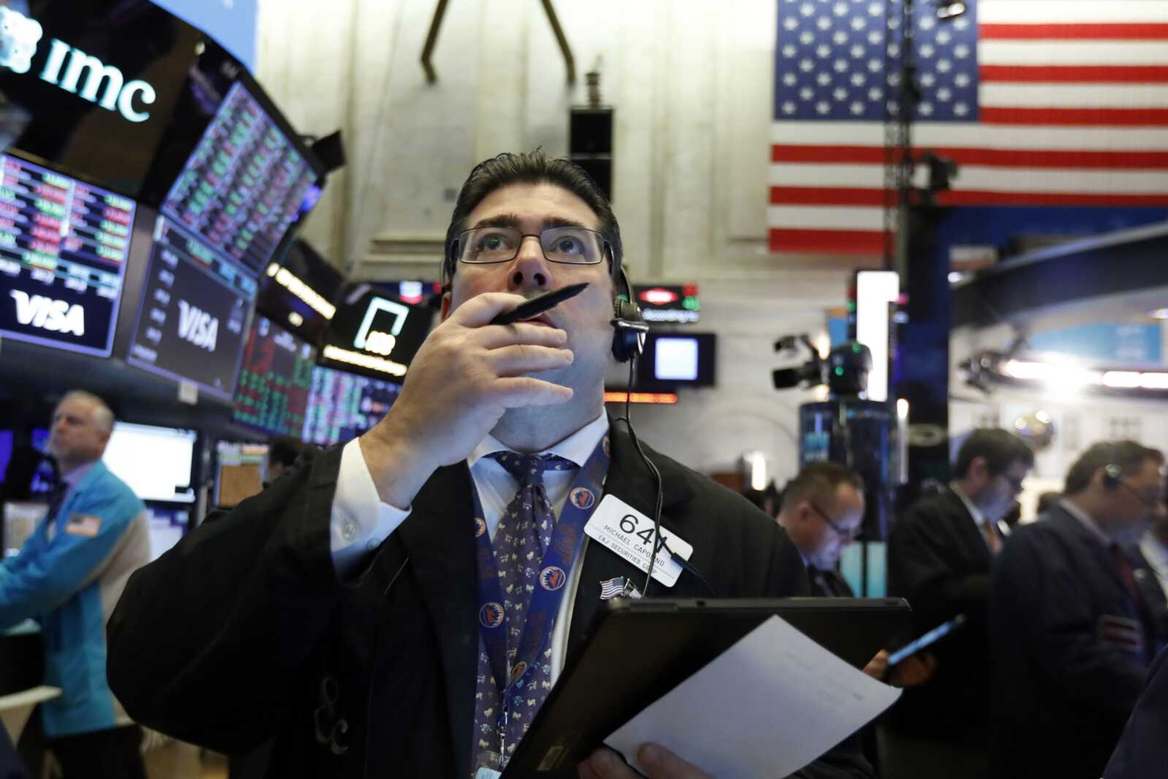 Trader Michael Capolino works Tuesday on the floor of the New York Stock Exchange. Stocks continued their slide even after an interest rate cut from the Federal Reserve.