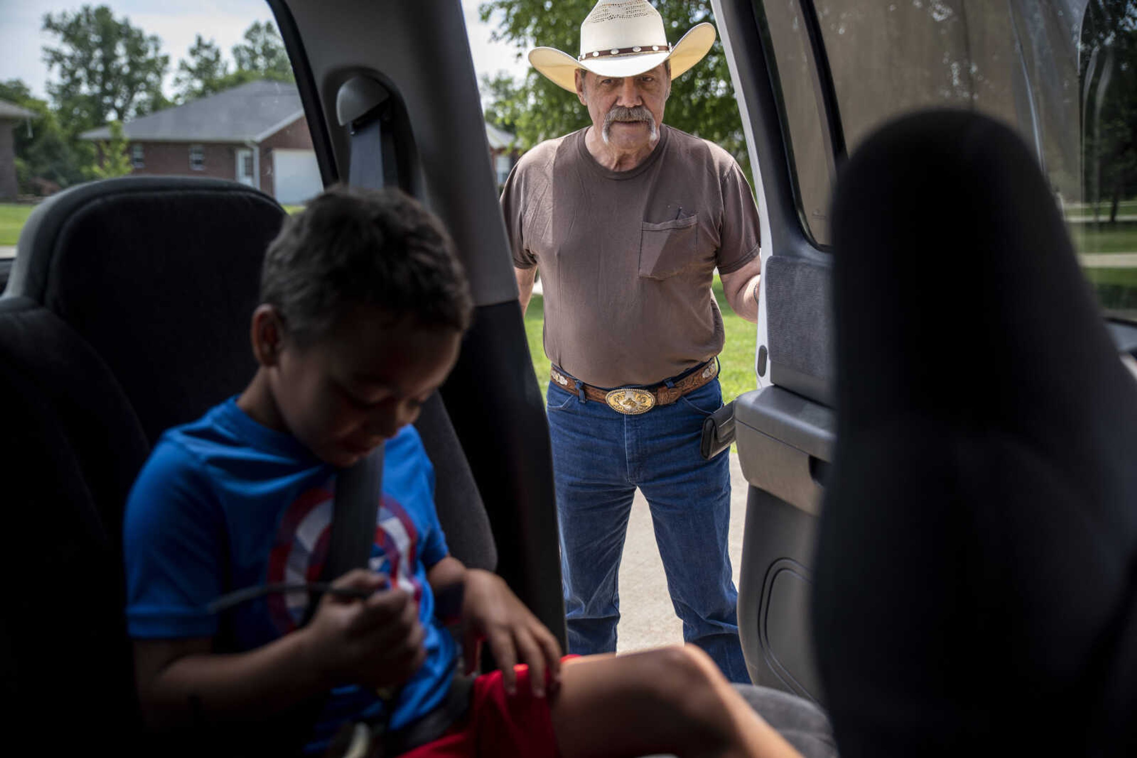 Carl Holmes looks at his great-grandson Jayce Holmes, 5, as he shuts his truck door after strapping Jayce in on their way to get haircuts Tuesday, June 11, 2019, in Jackson.