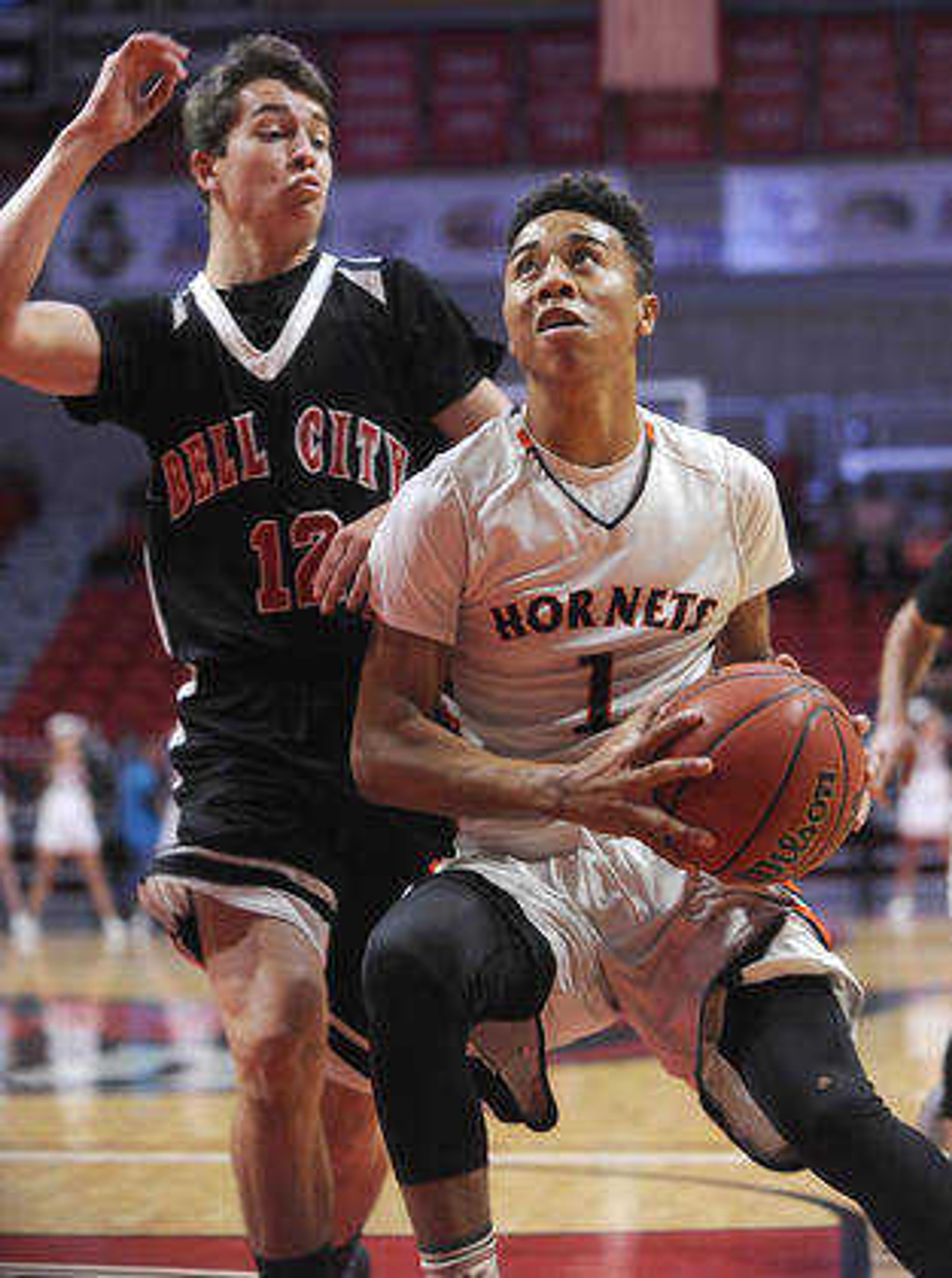 Advance's Armani Vermillion drives against Bell City's Cole Nichols during the first quarter in a first-round game of the Southeast Missourian Christmas Tournament Saturday, Dec. 26, 2015 at the Show Me Center. (FRED LYNCH)