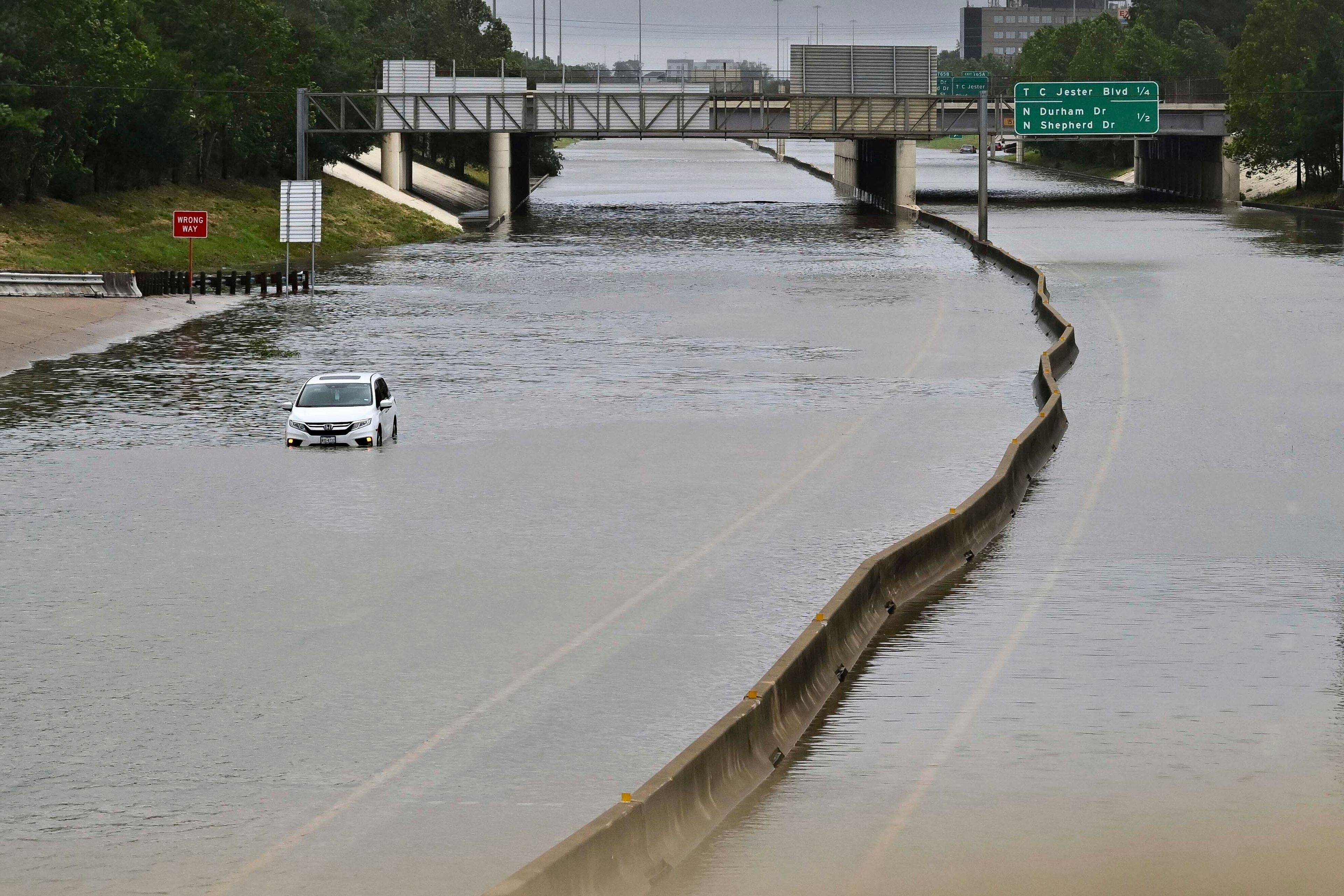 FILE - A vehicle is stranded in high waters on a flooded highway at Interstate 10 and Washington in Houston, on Monday, July 8, 2024, after Hurricane Beryl came ashore. (AP Photo/Maria Lysaker, File)