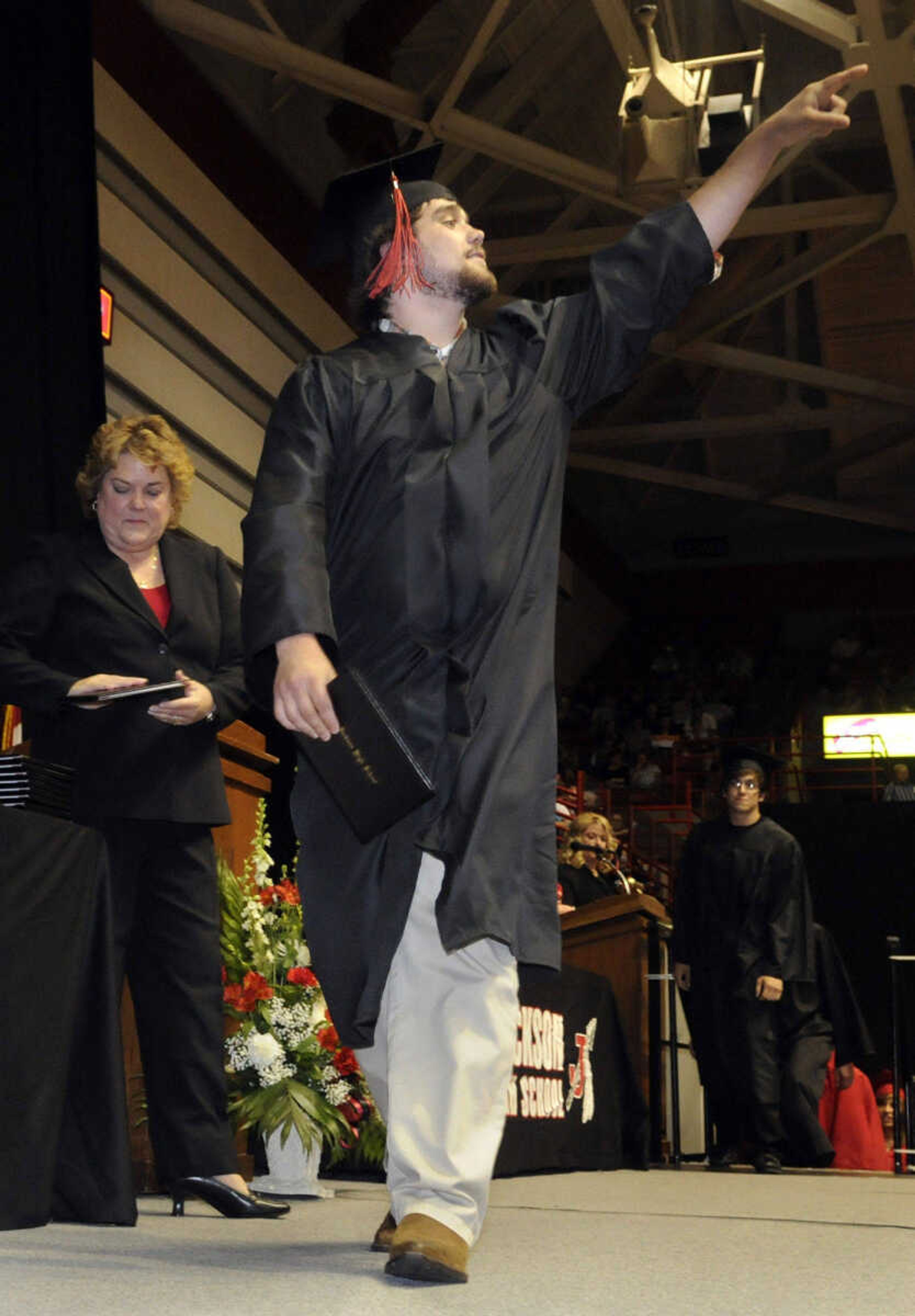 KRISTIN EBERTS ~ keberts@semissourian.com

Jack Huskey gestures to the crowd while crossing the stage during Jackson High School's commencement ceremony at the Show Me Center in Cape Girardeau, Mo., on Thursday, May 20, 2010.