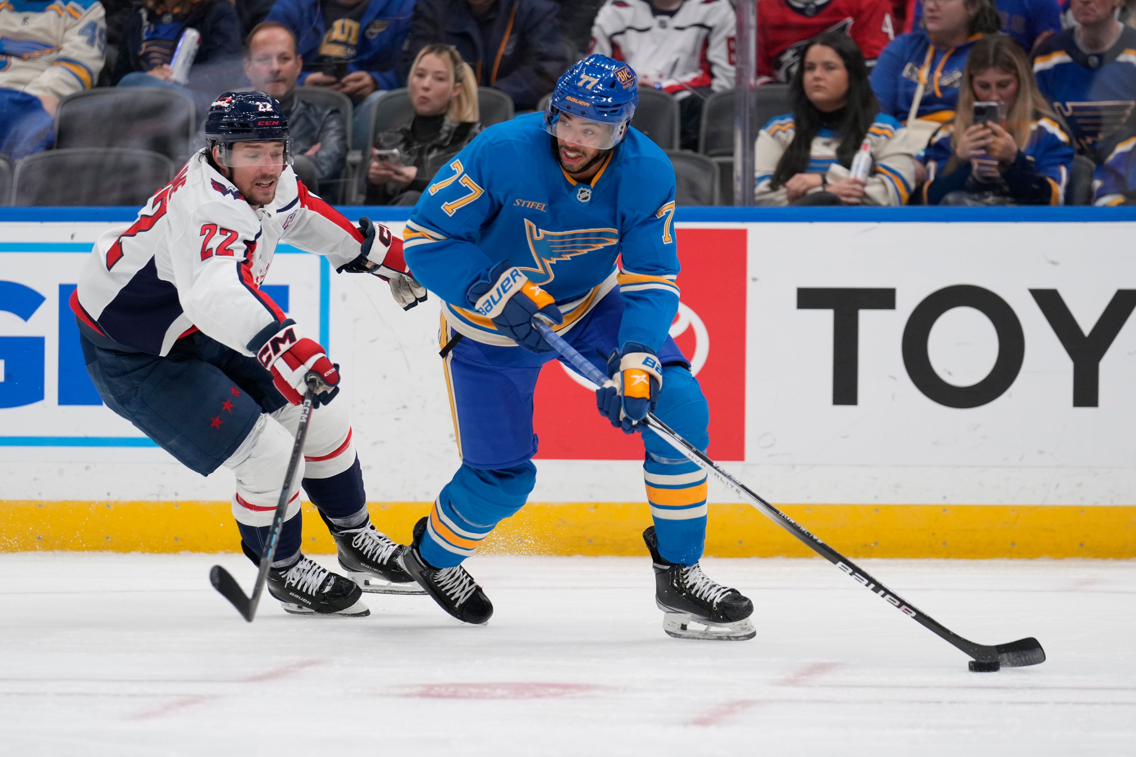 St. Louis Blues' Pierre-Olivier Joseph (77) handles the puck as Washington Capitals' Brandon Duhaime (22) during the first period of an NHL hockey game Saturday, Nov. 9, 2024, in St. Louis. (AP Photo/Jeff Roberson)