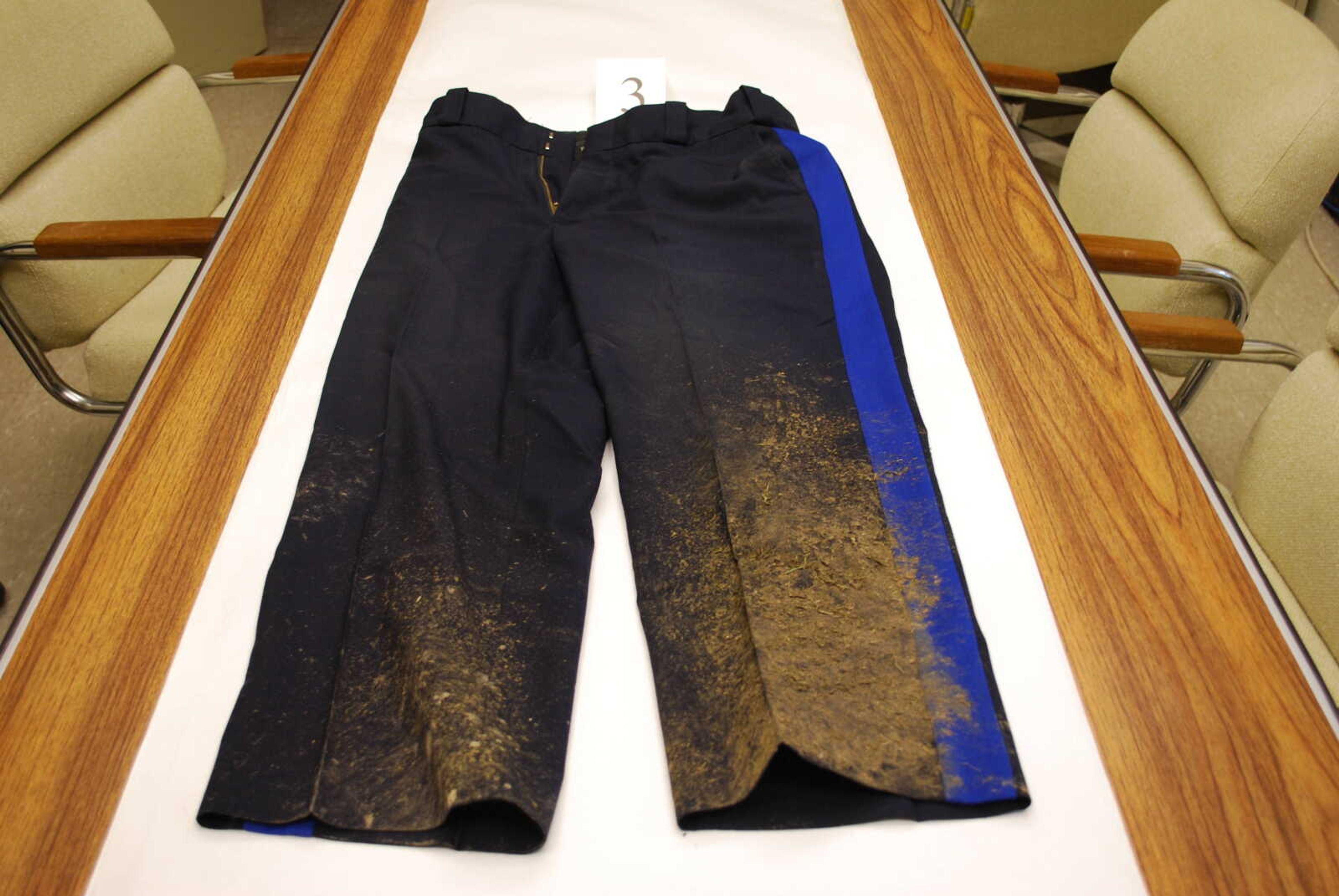 A photo submitted as evidence shows mud caked on the pants of trooper Jason McBride.