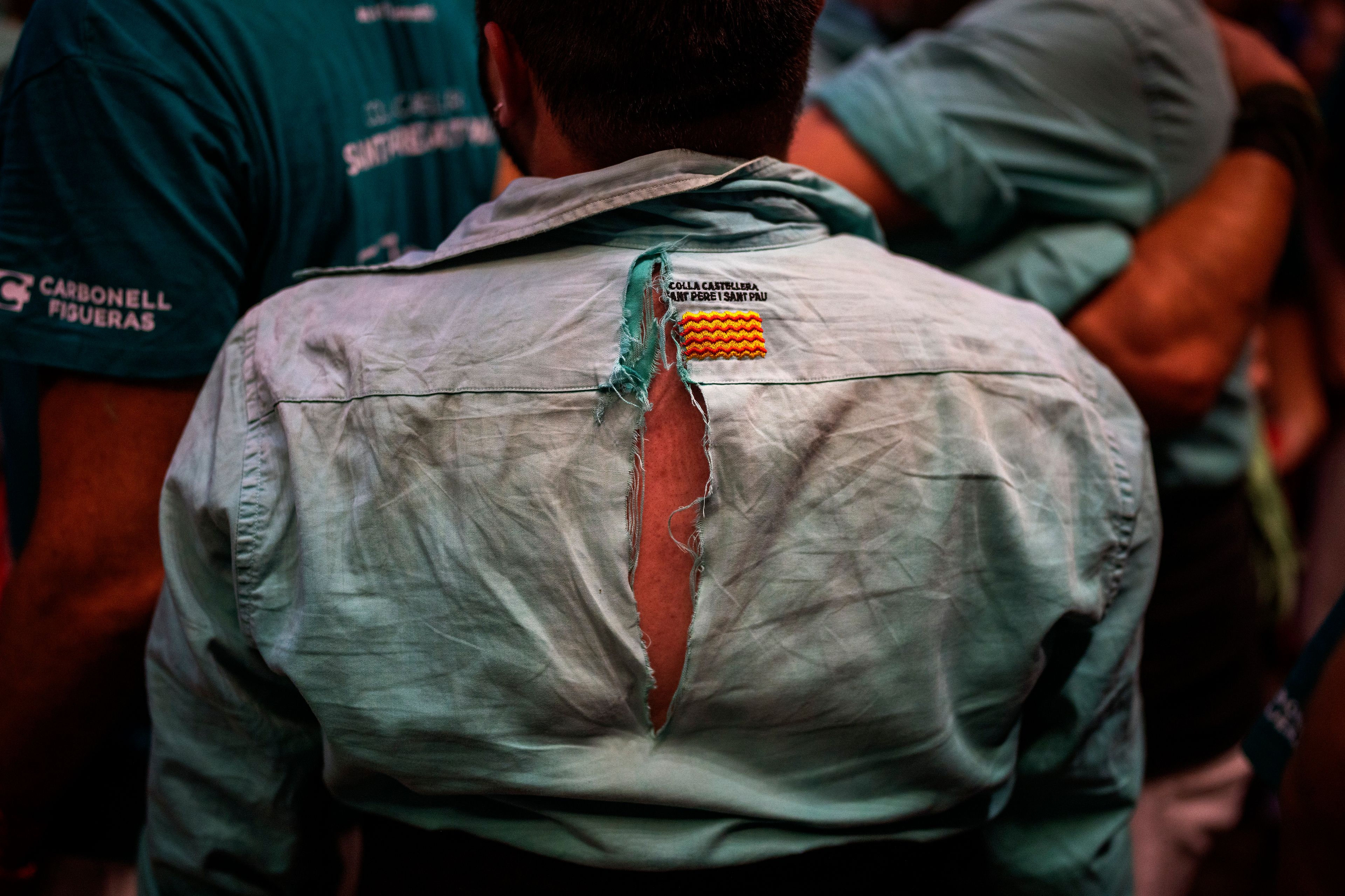 The torn shirt of an assistant is photographed after completing a "Castellers" or human tower during the 29th Human Tower Competition in Tarragona, Spain, Saturday, Oct. 5, 2024. (AP Photo/Emilio Morenatti)