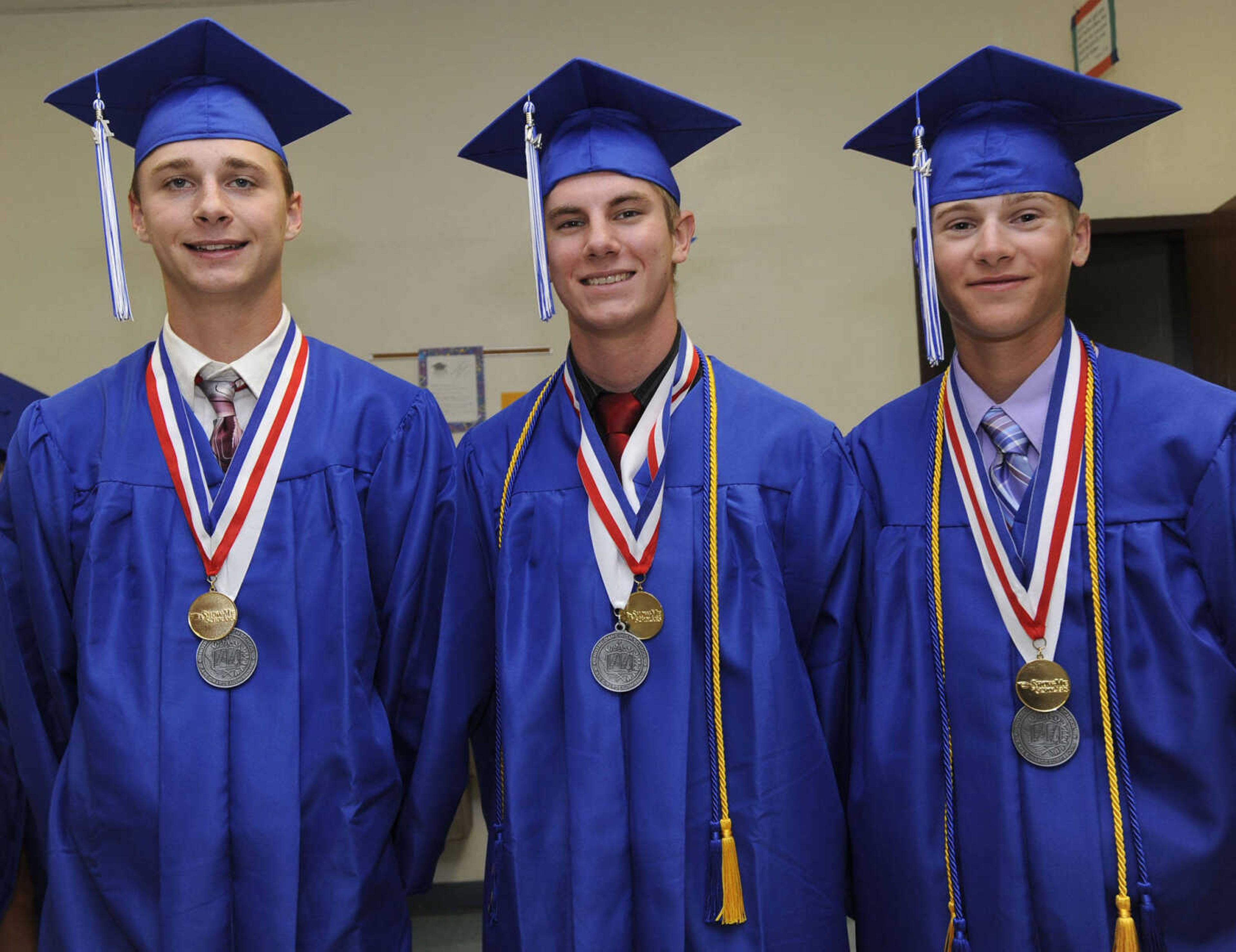 Cole Schreiner, left, Nick Pfau and Alex Wikel pose for a photo at the Notre Dame Regional High School commencement Sunday, May 18, 2014.