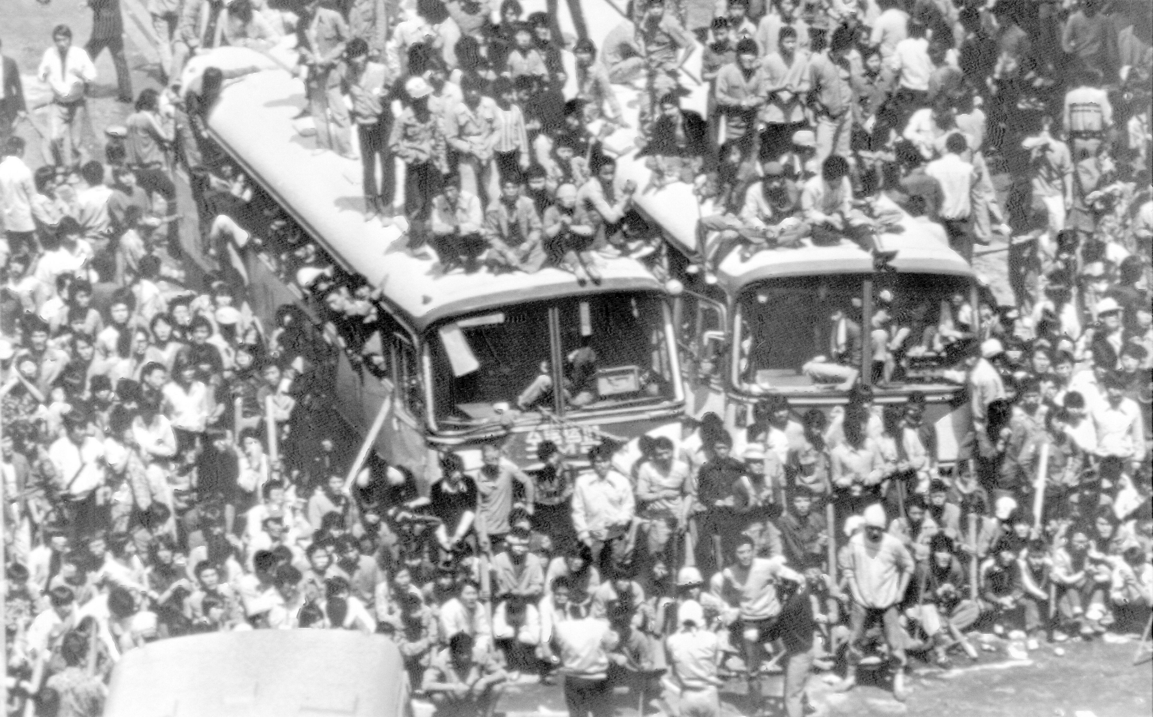 FILE- Commandeered city buses are used to block a main downtown street of Gwangju (Kwangju), May 23, 1980 by demonstrators against riot police and paratroopers during riotous anti-government protests this week. (AP Photo/File)