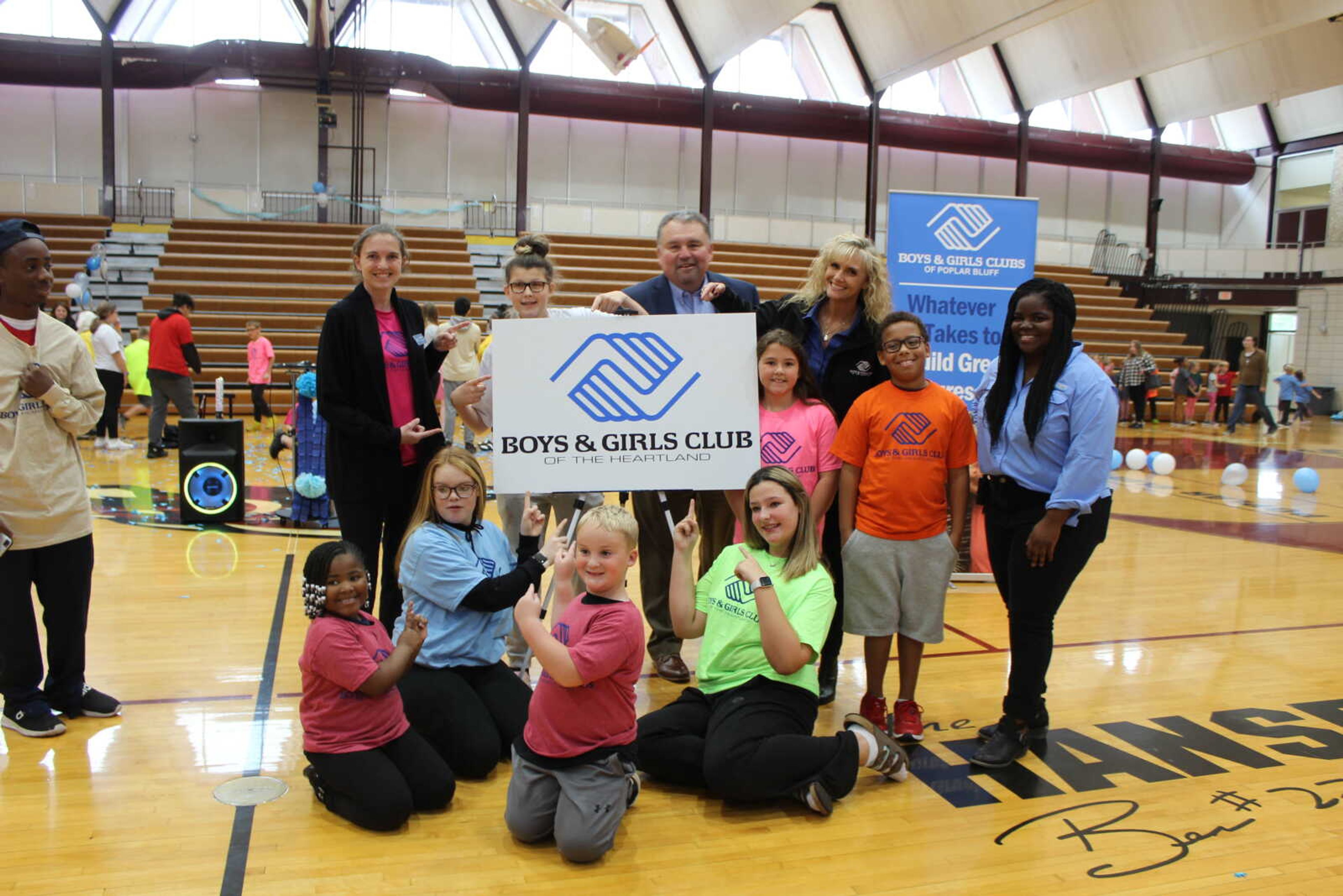 The Boys & Girls Club of the Heartland based in Poplar Bluff, Mo., pose with Chris Rushin, chief professional officer for the Heartland group. Rushin said the group has a partnership with Three Rivers College to enable high school students to earn college credit.
