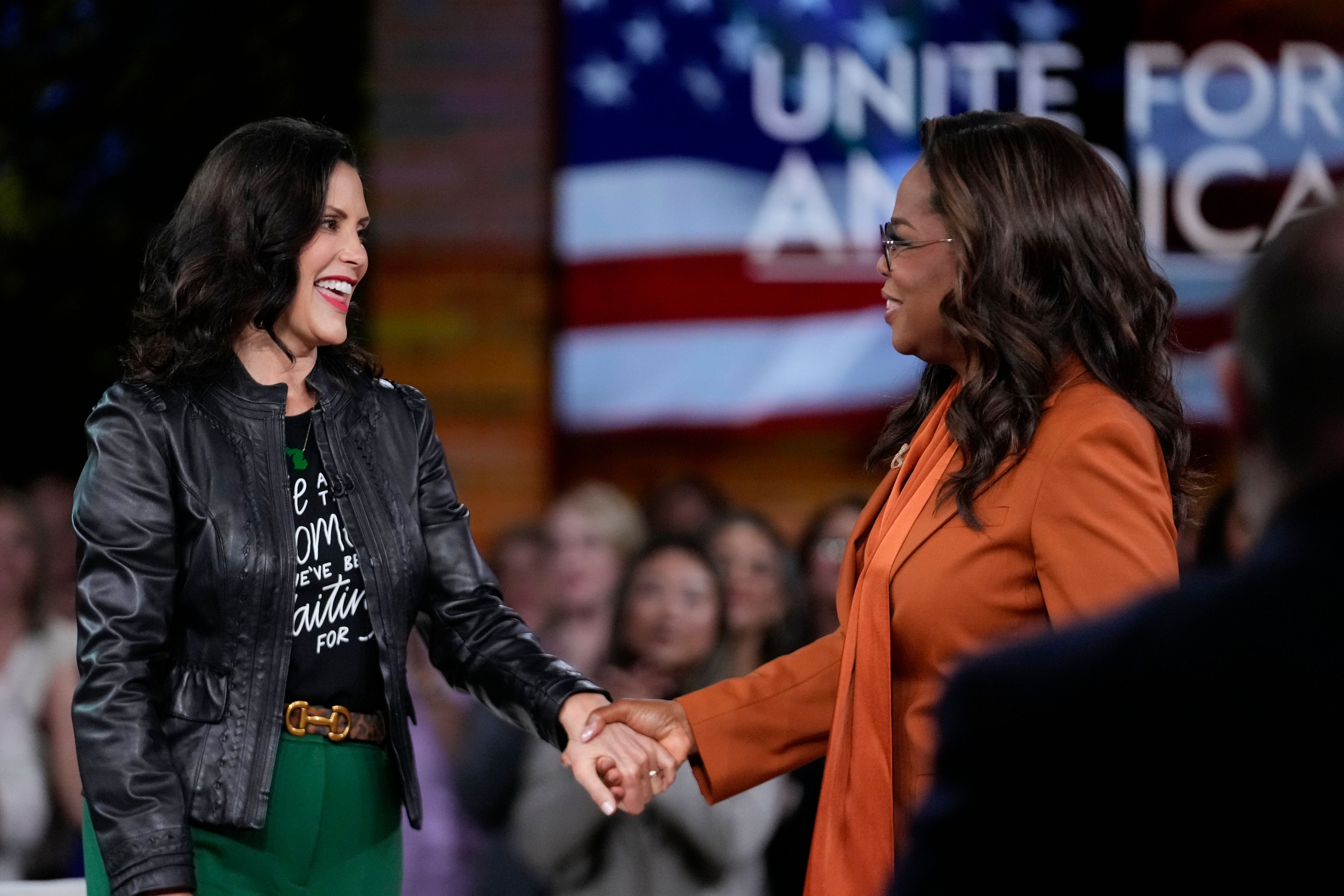 Michigan Gov. Gretchen Whitmer, left, joins Oprah Winfrey before the arrival of Democratic presidential nominee Vice President Kamala Harris at Oprah's Unite for America Live Streaming event Thursday, Sept. 19, 2024 in Farmington Hills, Mich. (AP Photo/Paul Sancya)