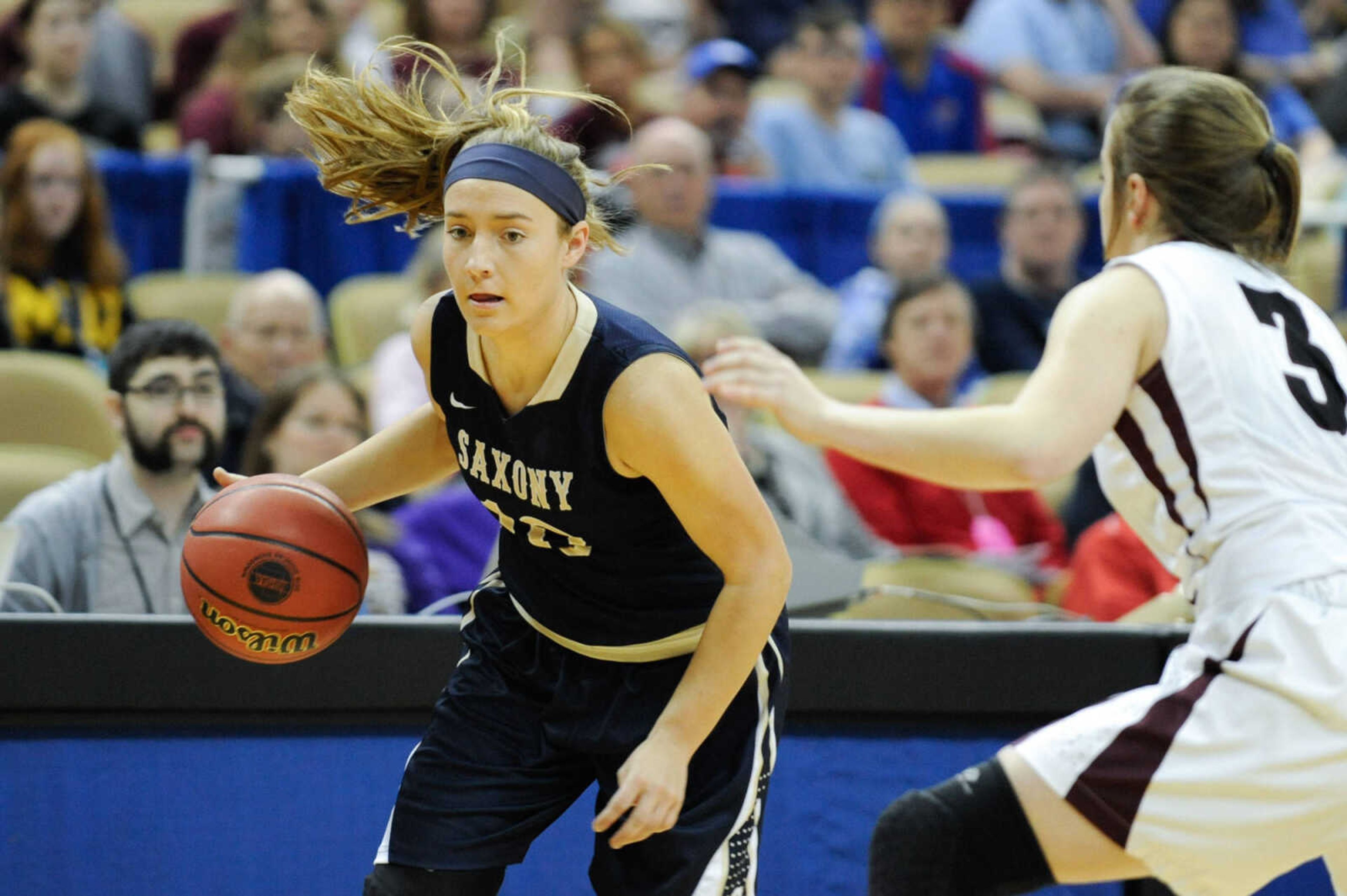 Saxony Lutheran's Grace Mirly dribbles the basketball as Strafford's Abby Oliver defends during the Class 3 state championship on Friday at Mizzou Arena in Columbia, Missouri.