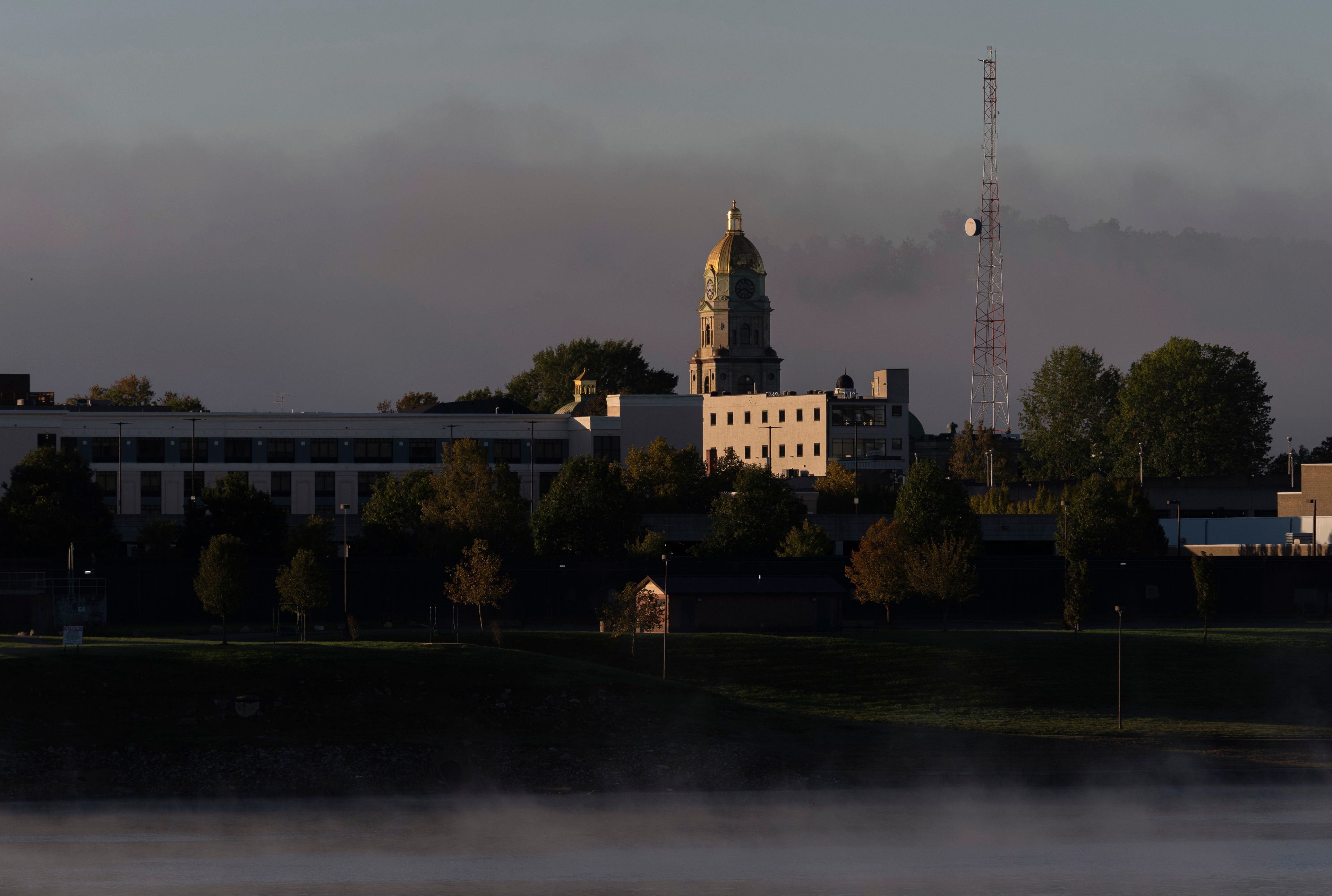 A light fog floats around the Cabell County Courthouse at sunrise in Huntington, W. Va. across the Ohio River from Chesapeake, Ohio, Thursday, Oct. 10, 2024. (AP Photo/Carolyn Kaster)