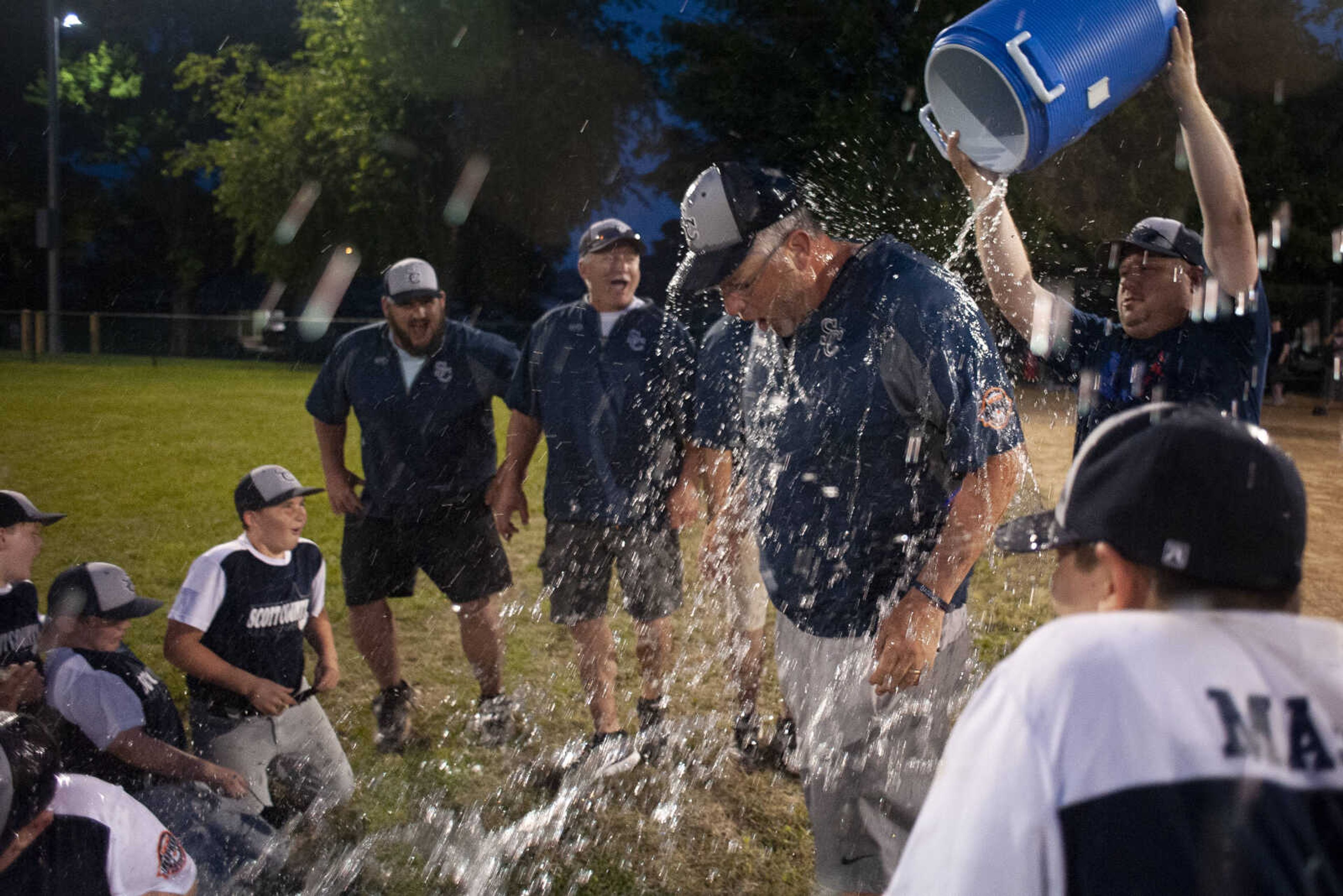 Scott County All-Stars head coach Matt Asher gets doused in liquid following the team's 5-2 victory over the SEMO Cardinals in the championship game of the 2019 Kelso 11U Showdown on Sunday, June 2, 2019, in Kelso.