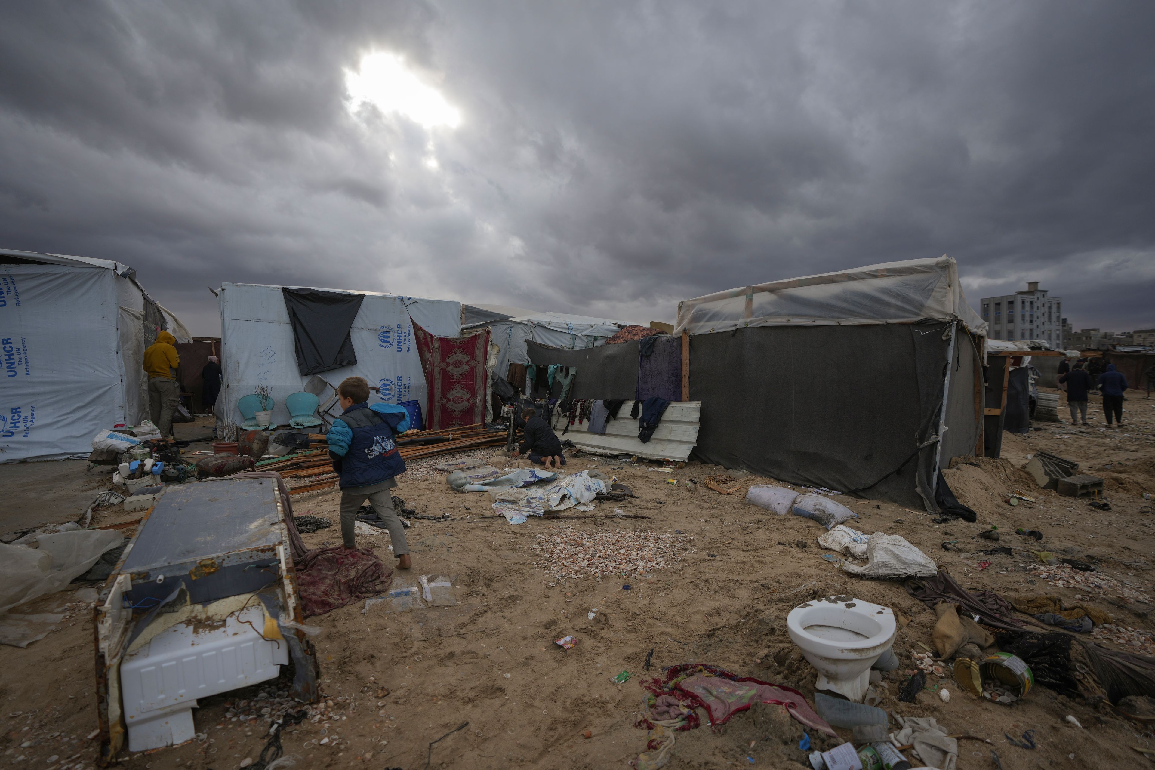 Storm clouds loom over the tents occupied by displaced Palestinians on the beach front in Deir al-Balah, Gaza Strip, Tuesday Nov. 26, 2024. (AP Photo/Abdel Kareem Hana)