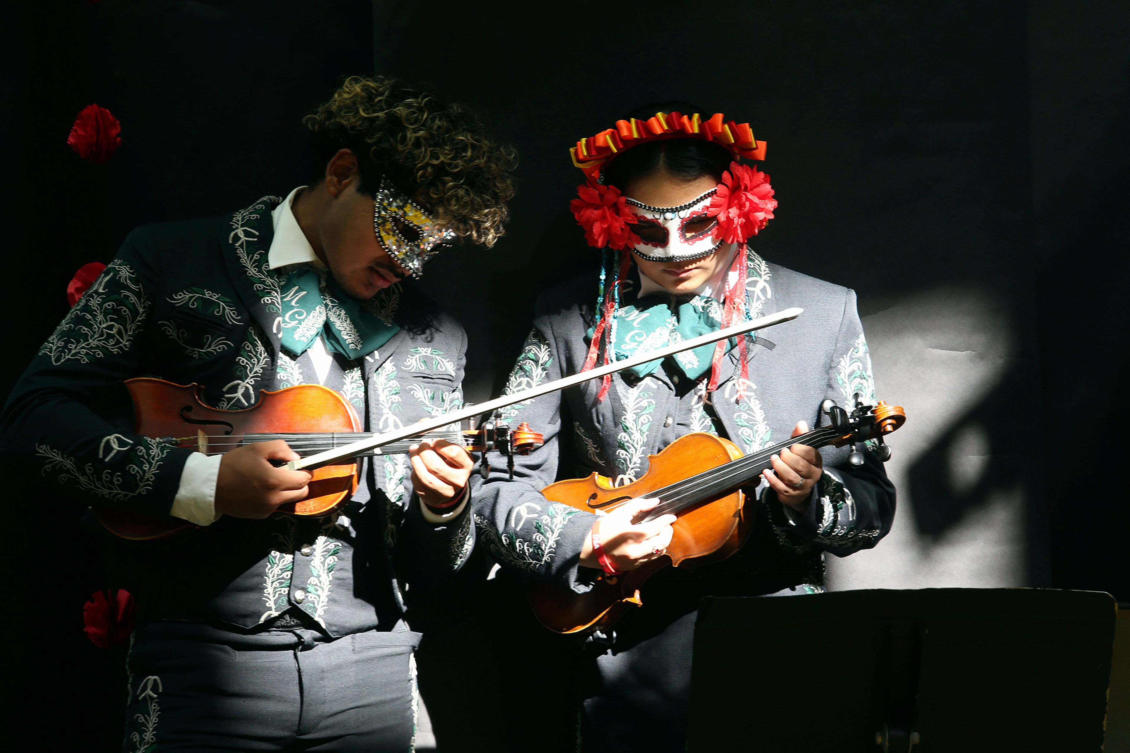 Members of the Pharr San Juan Alamo Memorial Early College Generaciones mariachi tune up during the 6th Annual Dia De Los Muertos Celebration at PSJA Memorial Early College High School, Friday Nov. 1,2024, in Alamo, Texas. (Delcia Lopez/The Monitor via AP)