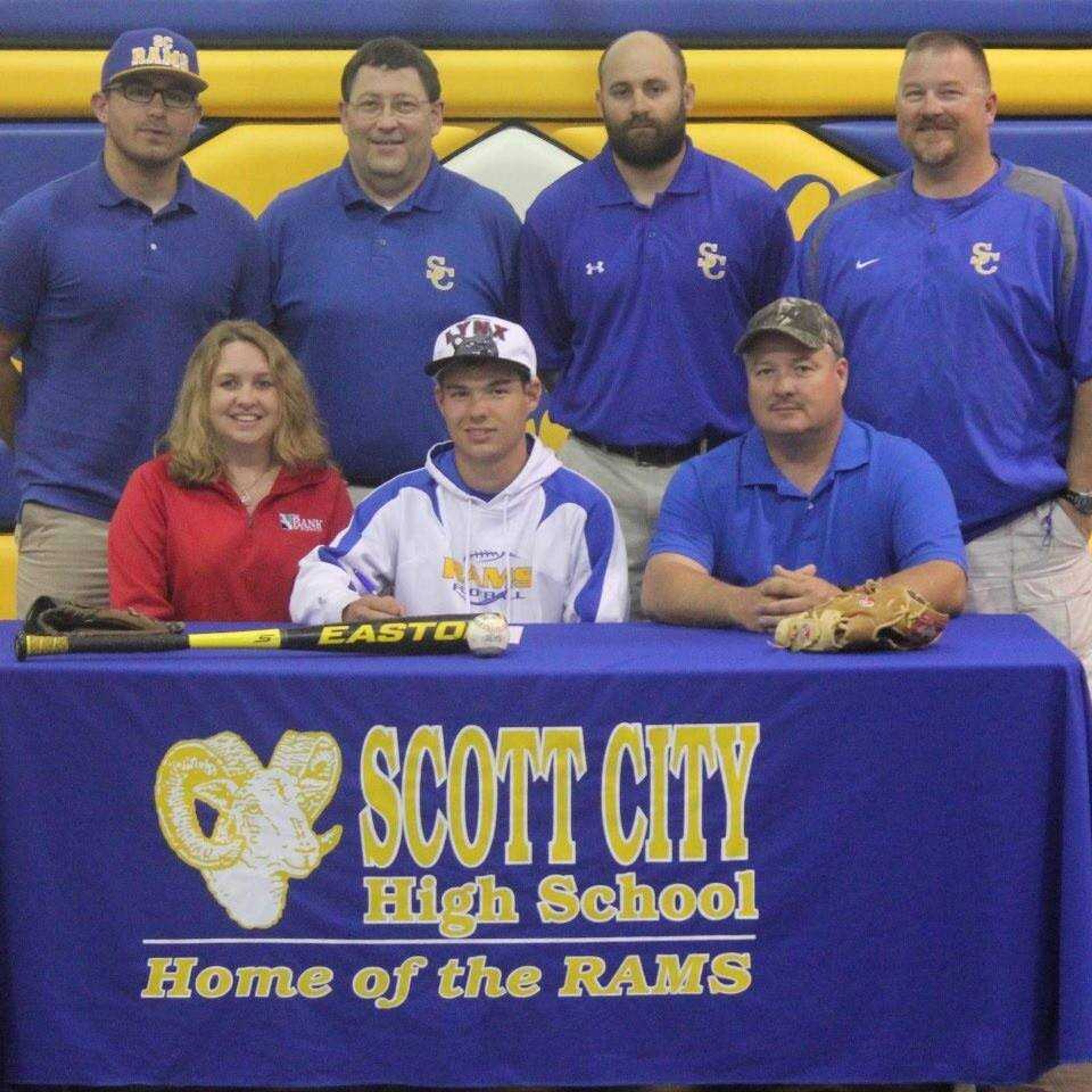 Forrest Copeland sign's with Lindenwood Belleville to play baseball. Pictured from left to right front row Mother Connie Copeland, Forrest Copeland Father Richard Copeland Back row from left to right is Coach Nick Grassi,Coach Kerry Thompson,Coach Lance Amick and Coach Jim May.