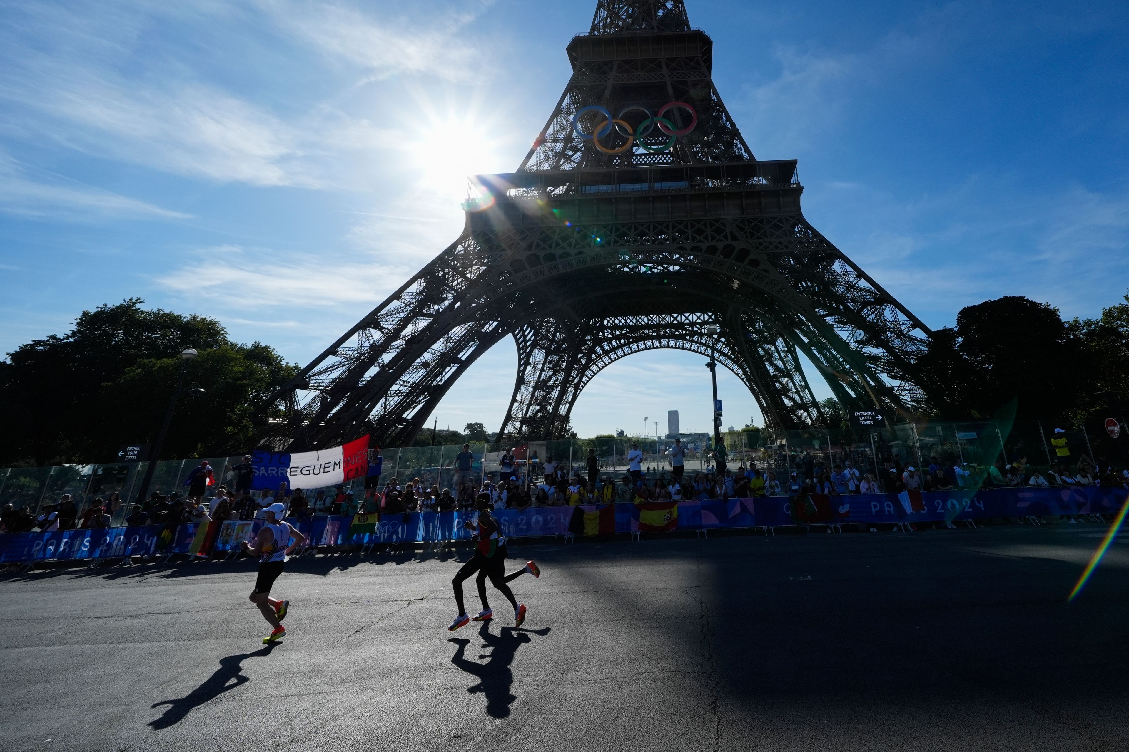 Competitors run past the Eiffel Tower during the men's marathon at the 2024 Summer Olympics, Saturday, Aug. 10, 2024, in Paris, France. (AP Photo/Rebecca Blackwell, Pool)