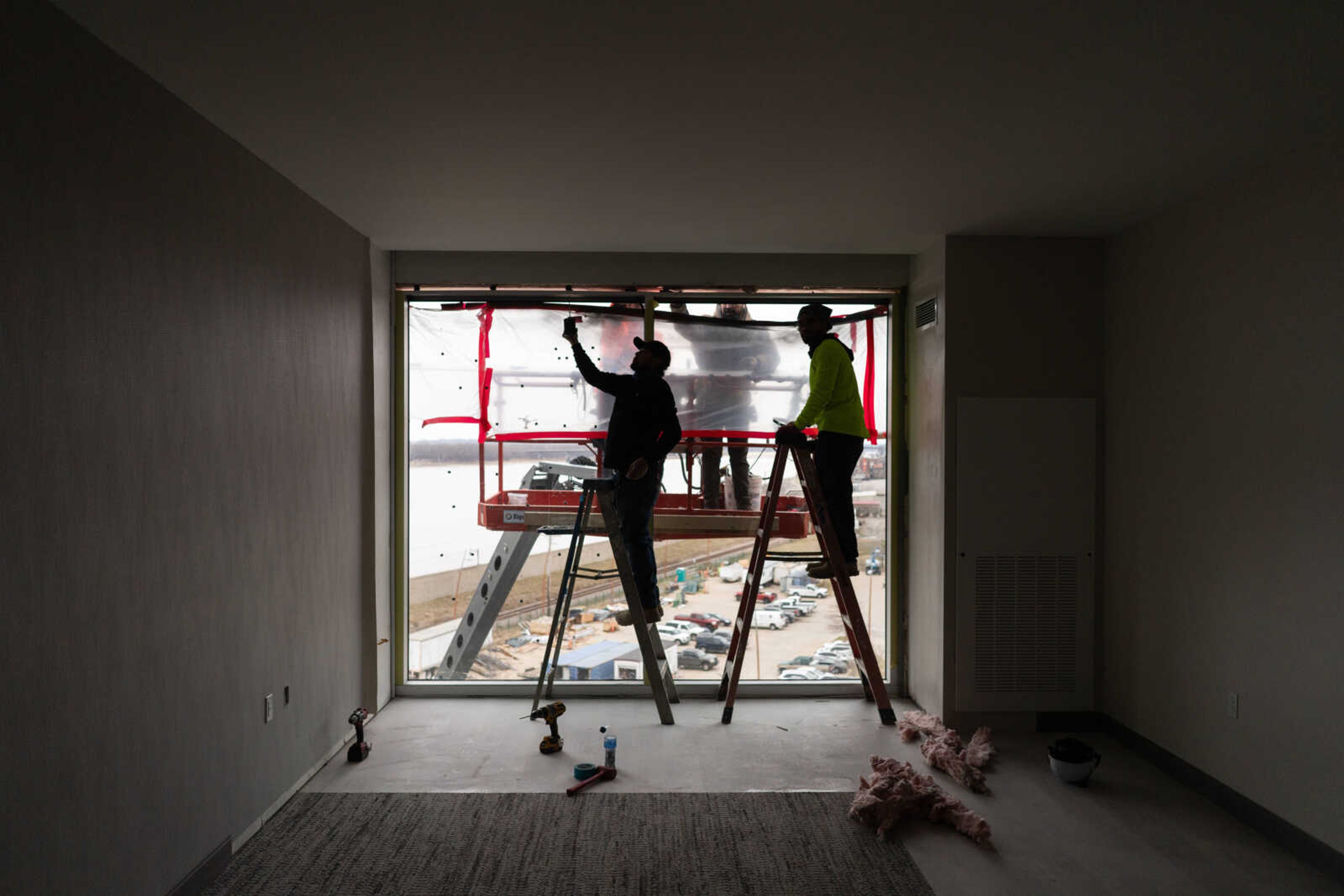 Workers finish up windows in one of the hotel rooms at The Riverview. The hotel will include an entrance to the casino and the casino's two dining establishments.