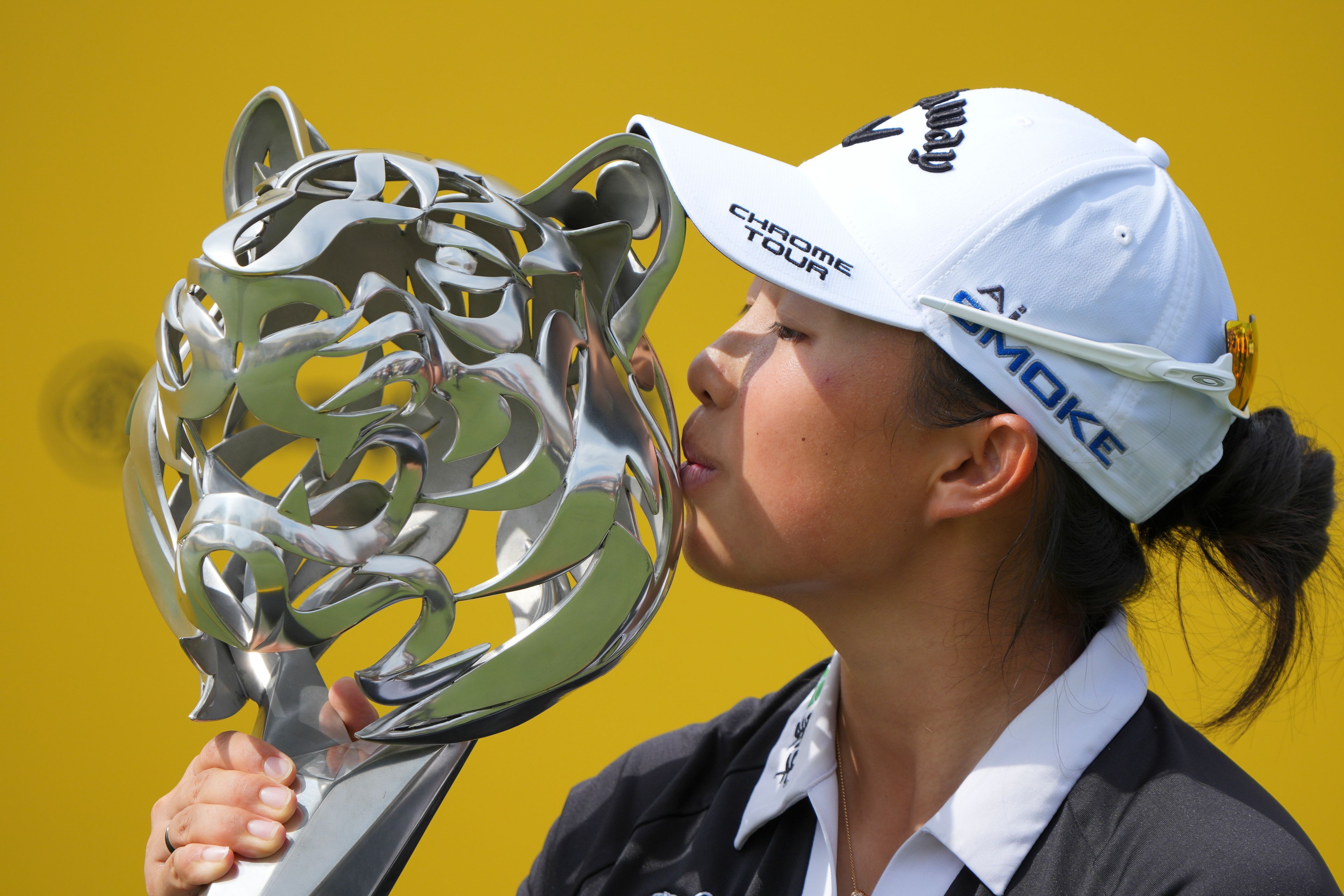 Yin Ruoning of China kisses the trophy during the awards ceremony after winning the LPGA Tour's Maybank Championship at Kuala Lumpur Golf and Country club in Kuala Lumpur, Sunday, Oct. 27, 2024. (AP Photo/Vincent Thian)