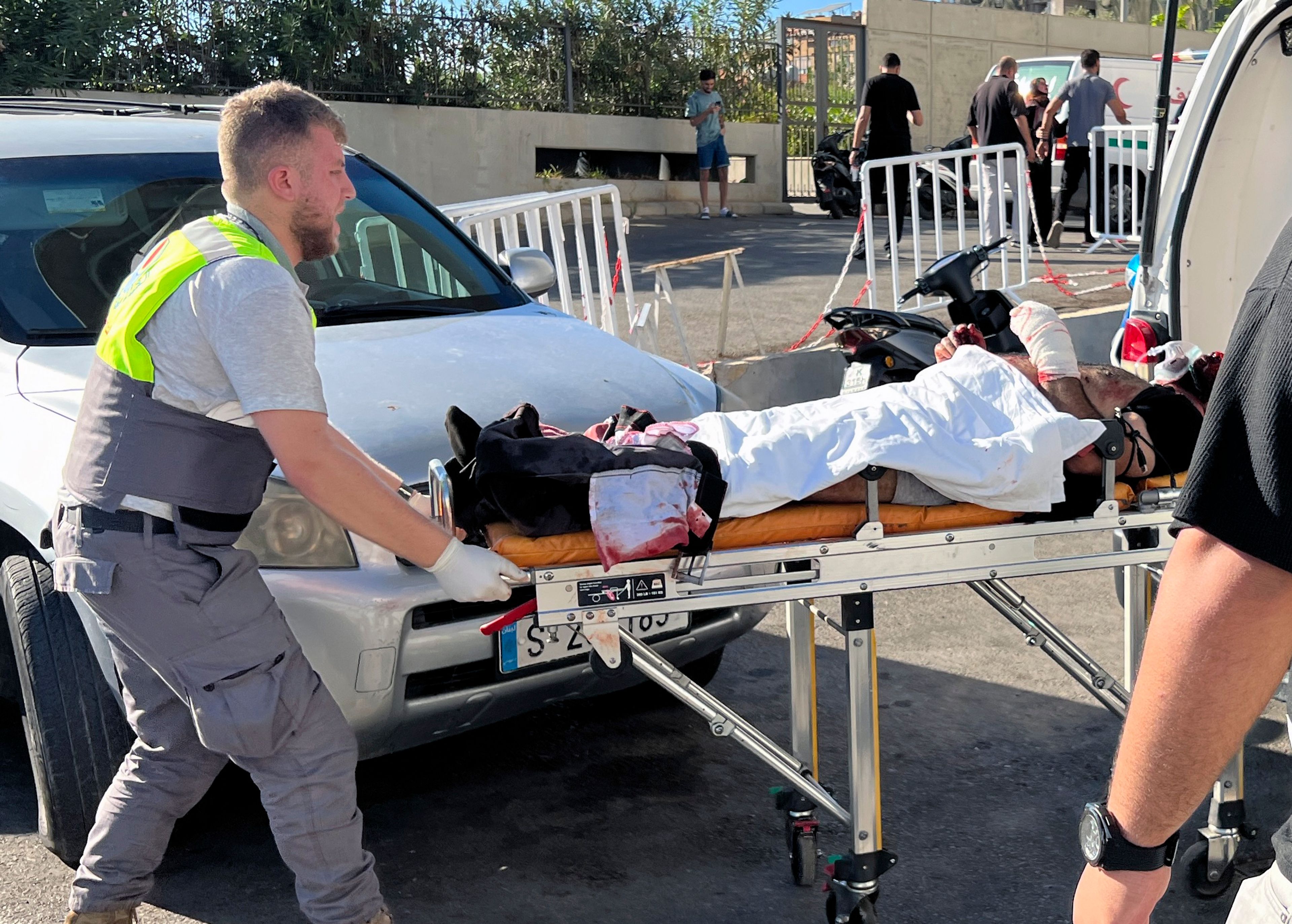 A Civil Defense first-responder carries a wounded man whose handheld pager exploded at al-Zahraa hospital in Beirut, Lebanon, Tuesday, Sept. 17, 2024. (AP Photo/Hussein Malla)