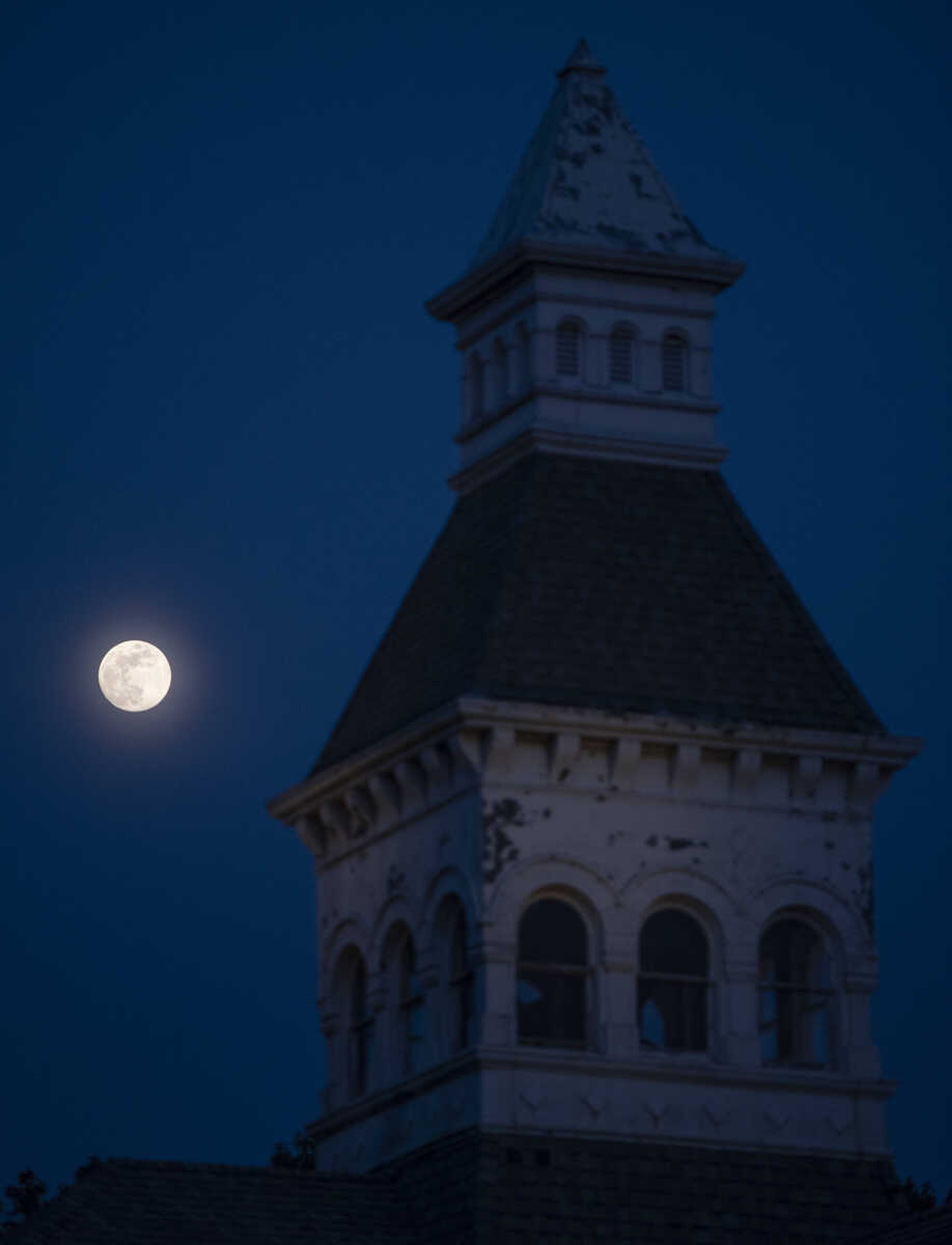 The moon is seen over Common Pleas Courthouse at the end of the season's first Tunes at Twilight on Friday, May 17, 2019, at Ivers Square in Cape Girardeau.