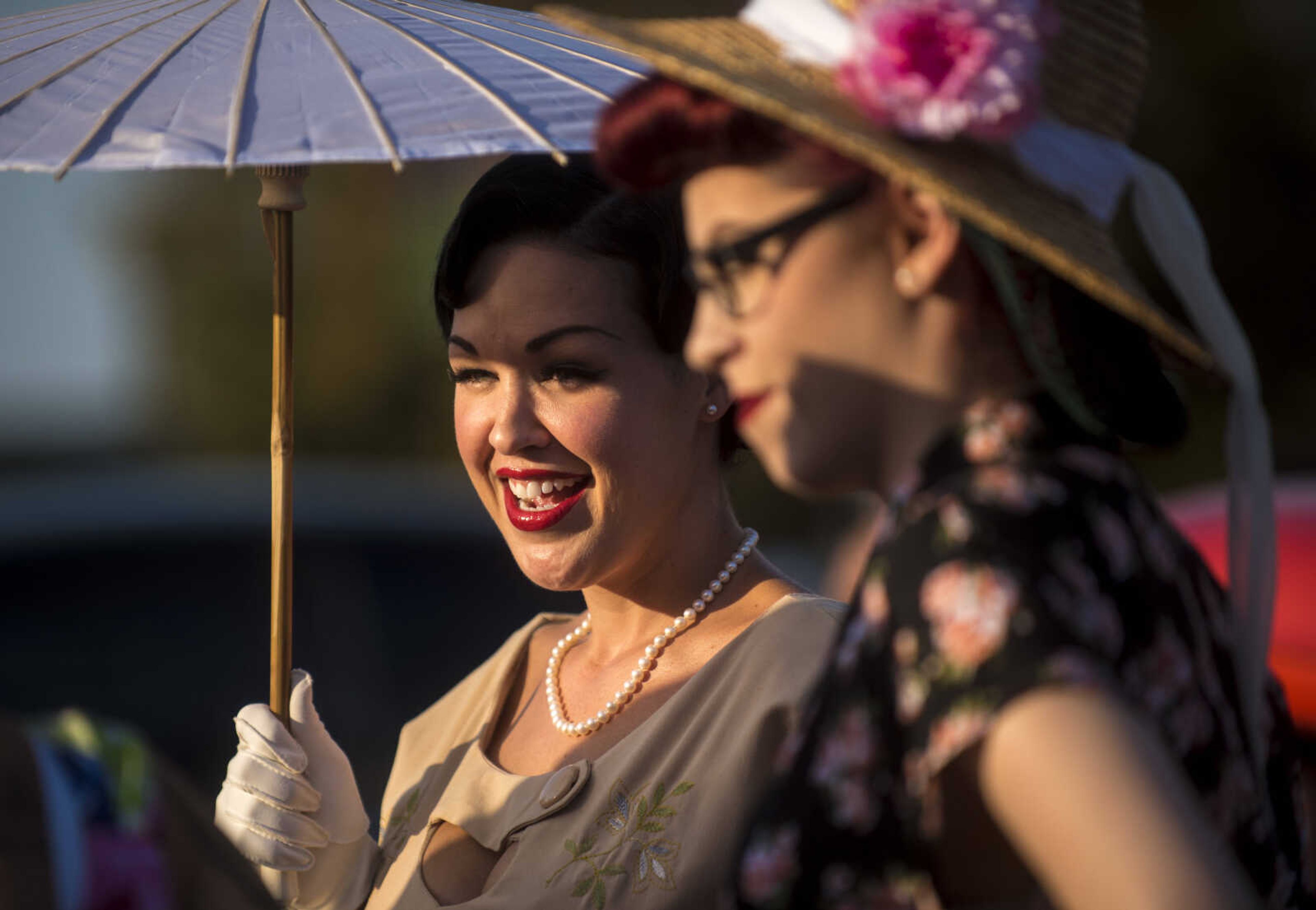 Stephanie Lombardo also known as Stella Noir, left, pose by cars during the Perryville Pinup contest Saturday, Sept. 2, 2017 in downtown Perryville.