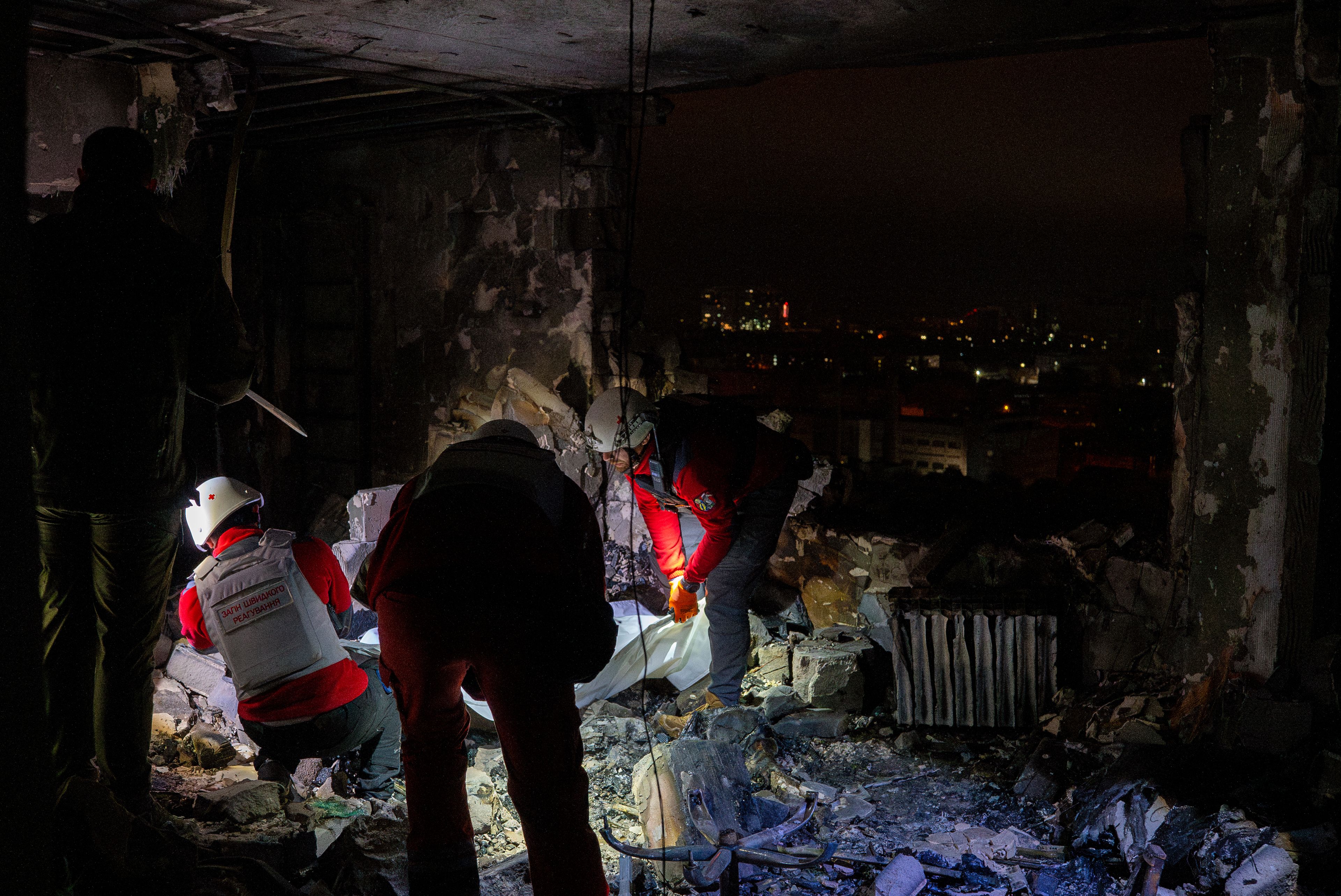 A medical emergency team collects the body of a victim who died after the Russian attack in Kyiv, Ukraine, Friday, Oct. 26, 2024. (AP Photo/Alex Babenko)