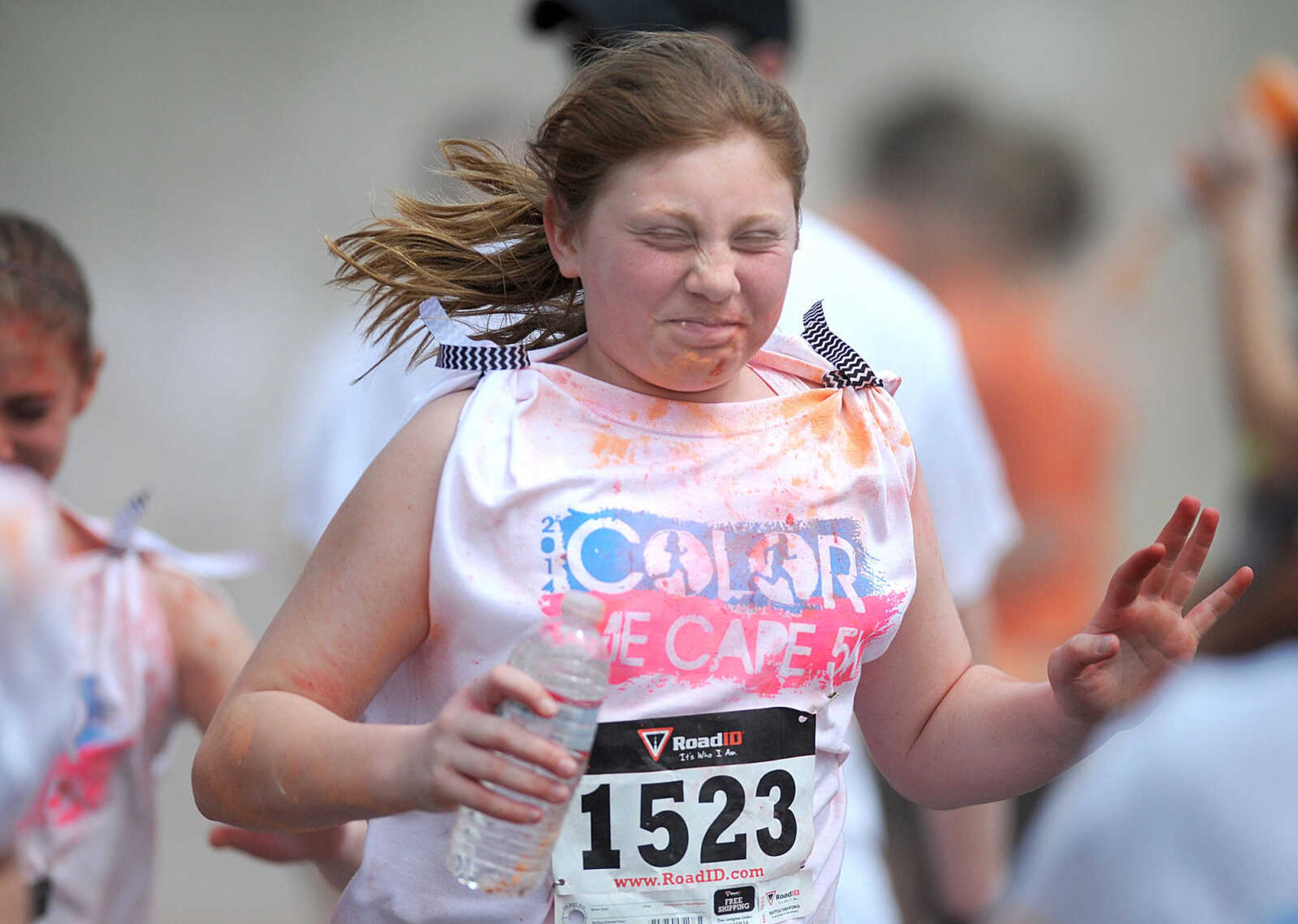 LAURA SIMON ~ lsimon@semissourian.com

Participants in the Color Me Cape 5K are sprayed with orange powder at the first color station on Good Hope Street, Saturday, April 12, 2014, in Cape Girardeau.