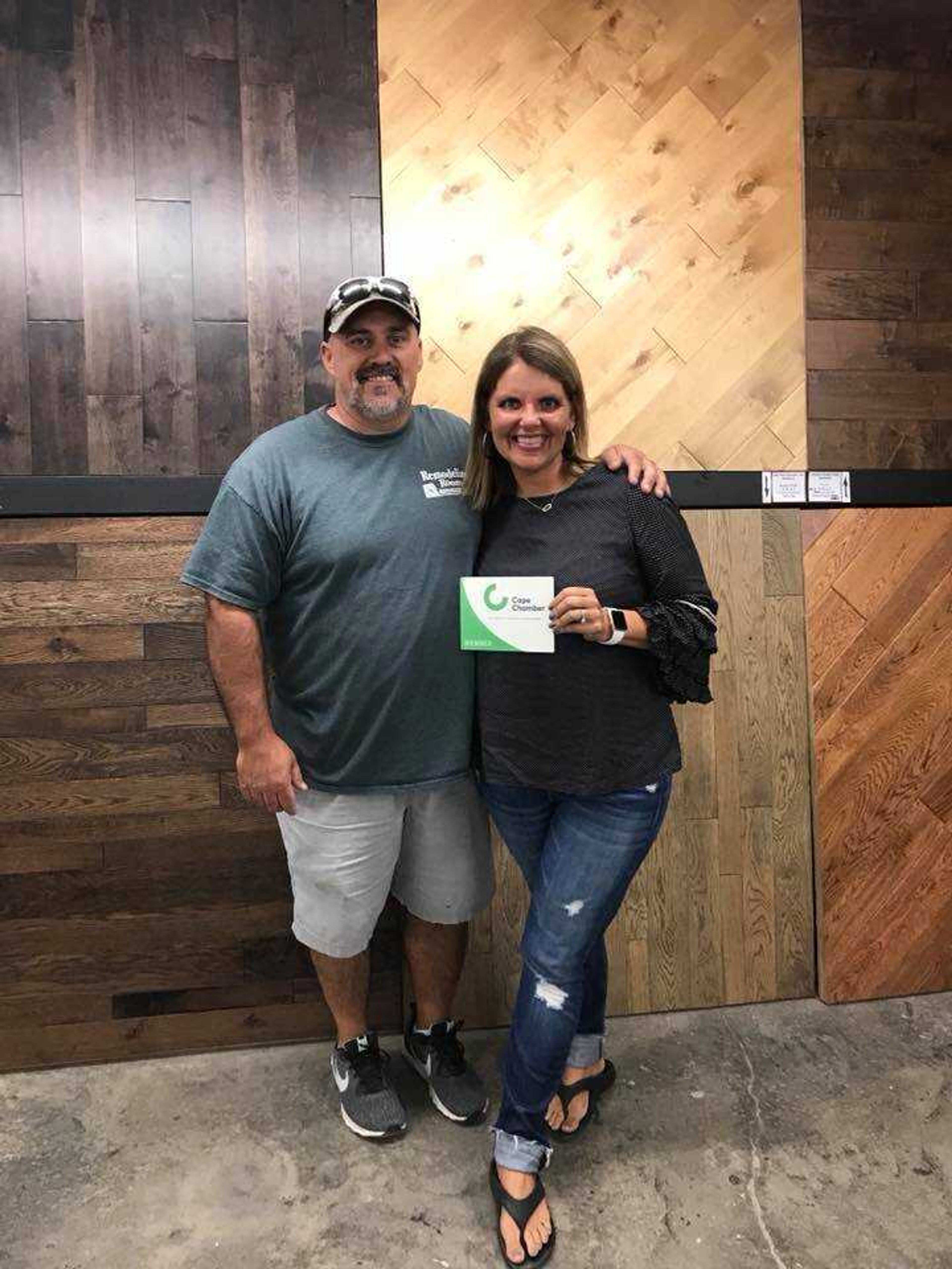 Owners of Remodeling Room pose with their membership plaque upon joining the Cape Chamber.